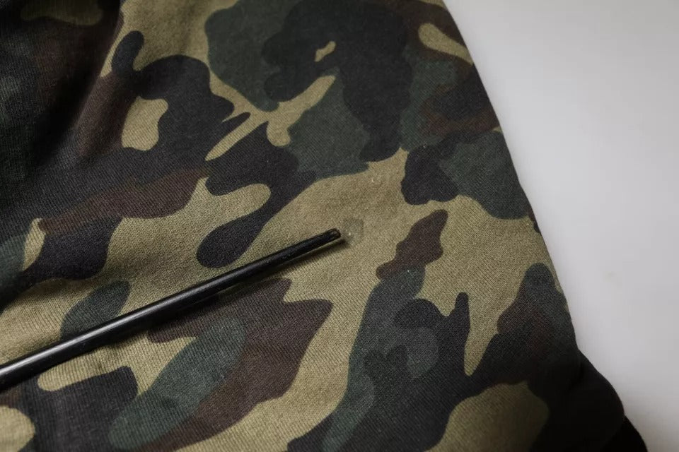 Camouflage fabric with a black needle threaded through it