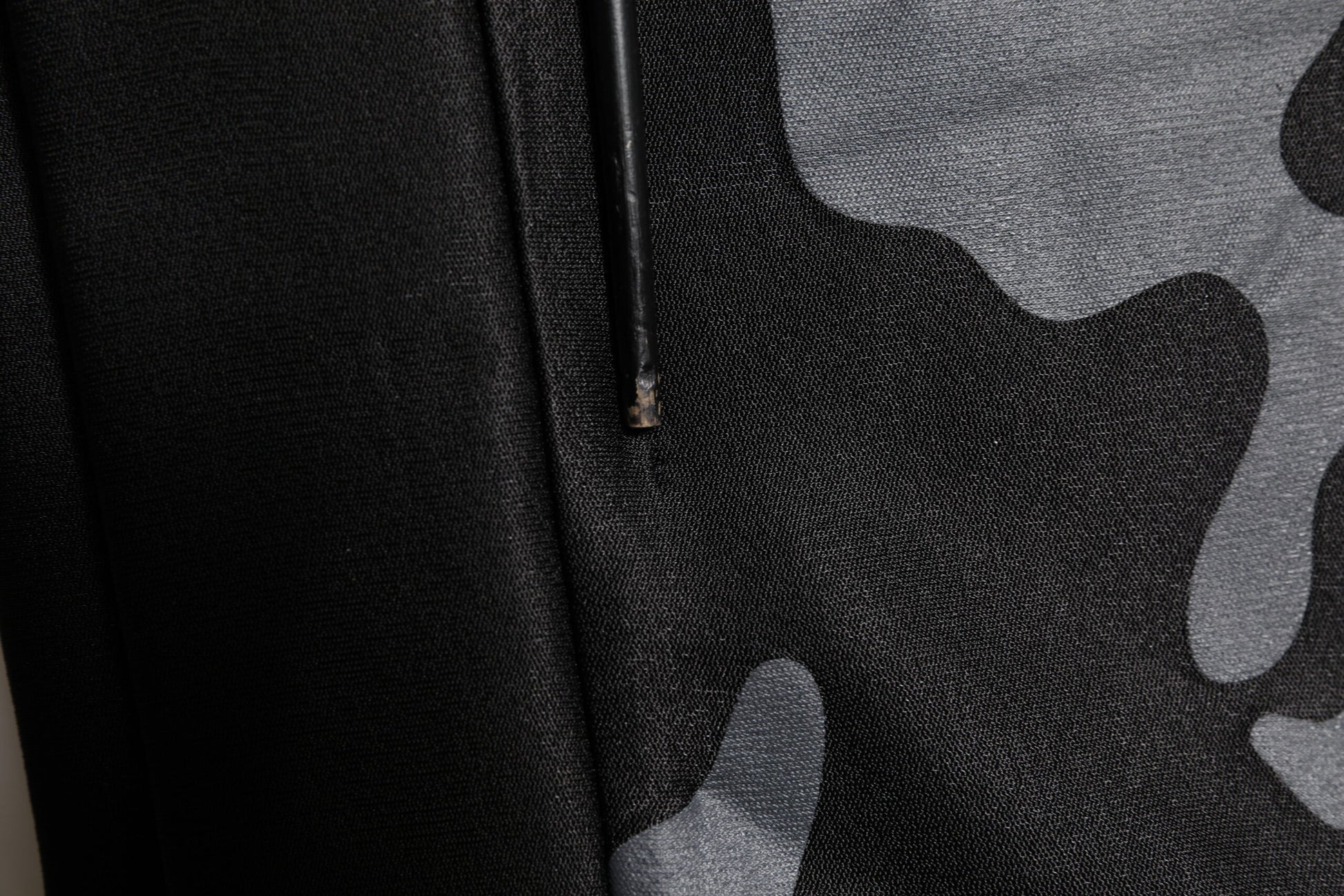 Black fabric with camouflage pattern
