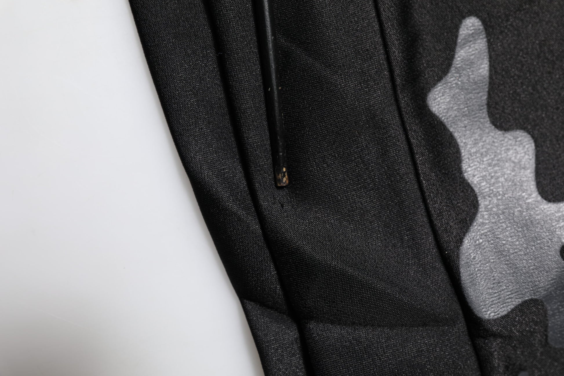 Black fabric with white pattern on sleeve