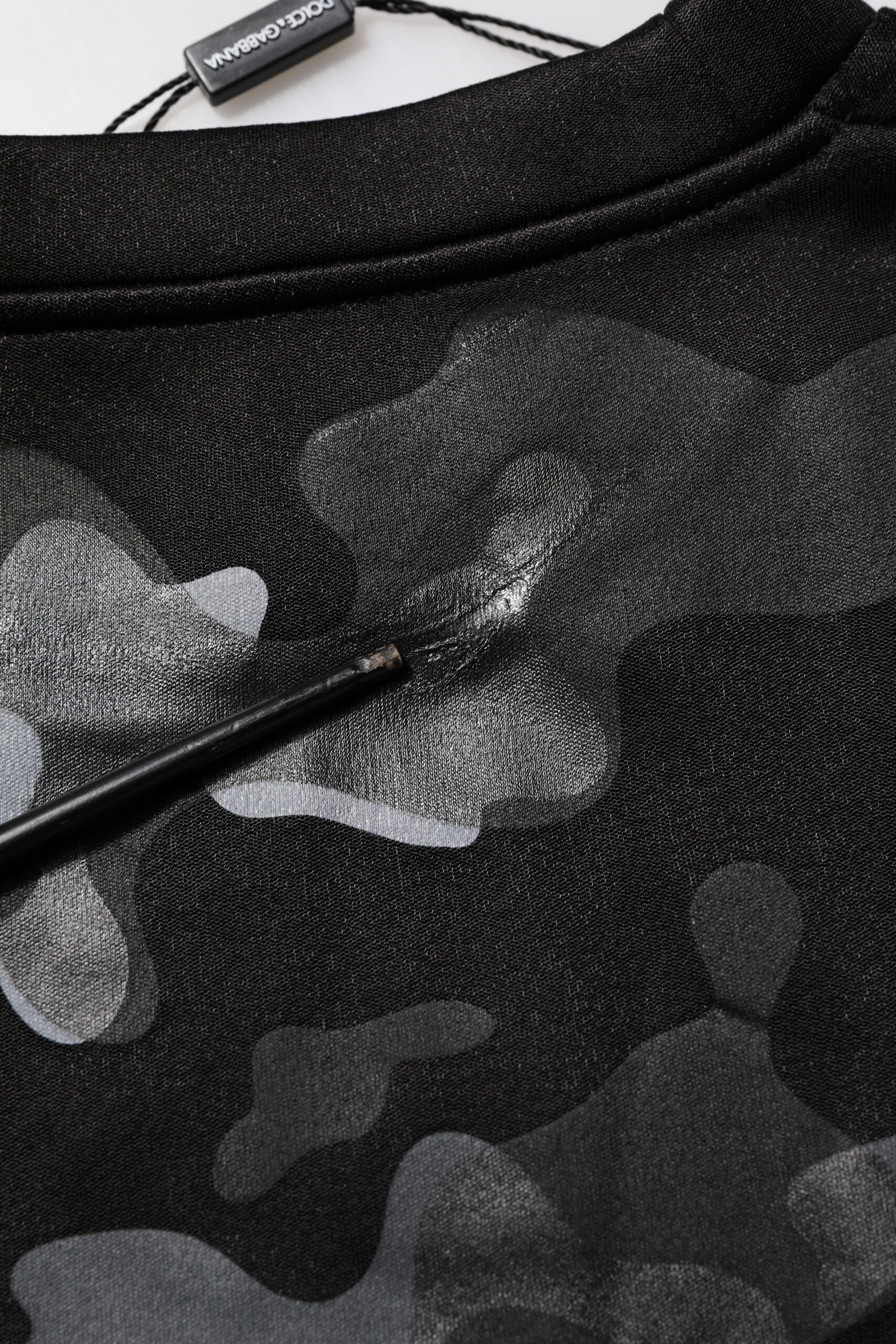 Black camouflage print shirt with white paint splatters on front
