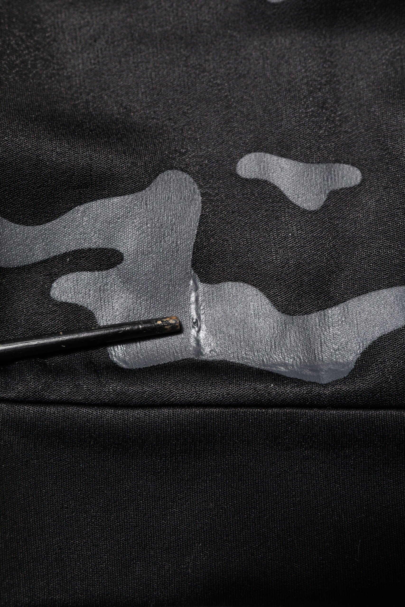 Black fabric with white camouflage pattern