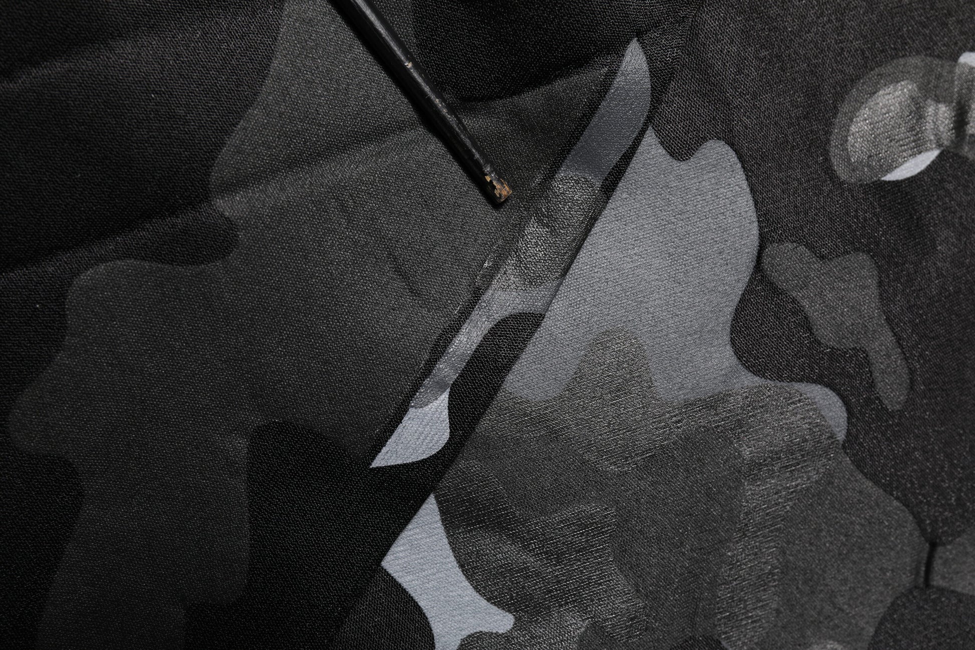 Black fabric with white design on front