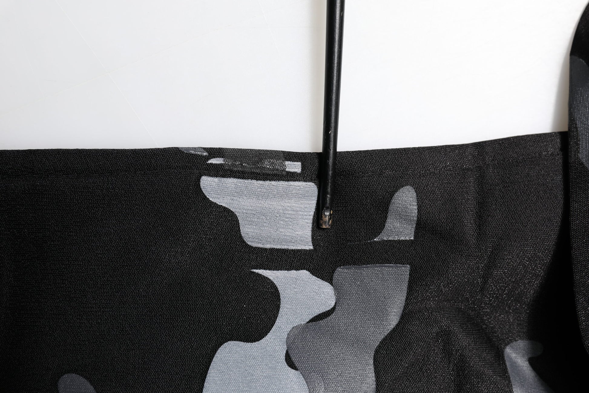 Black fabric with white pattern on a hanger
