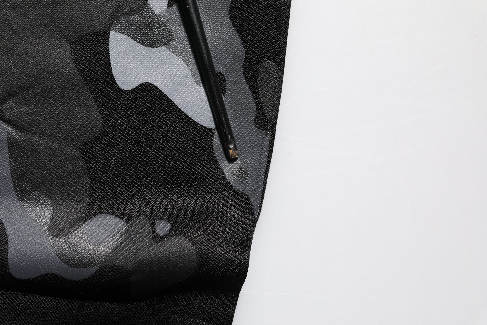 Black fabric with white design on paper