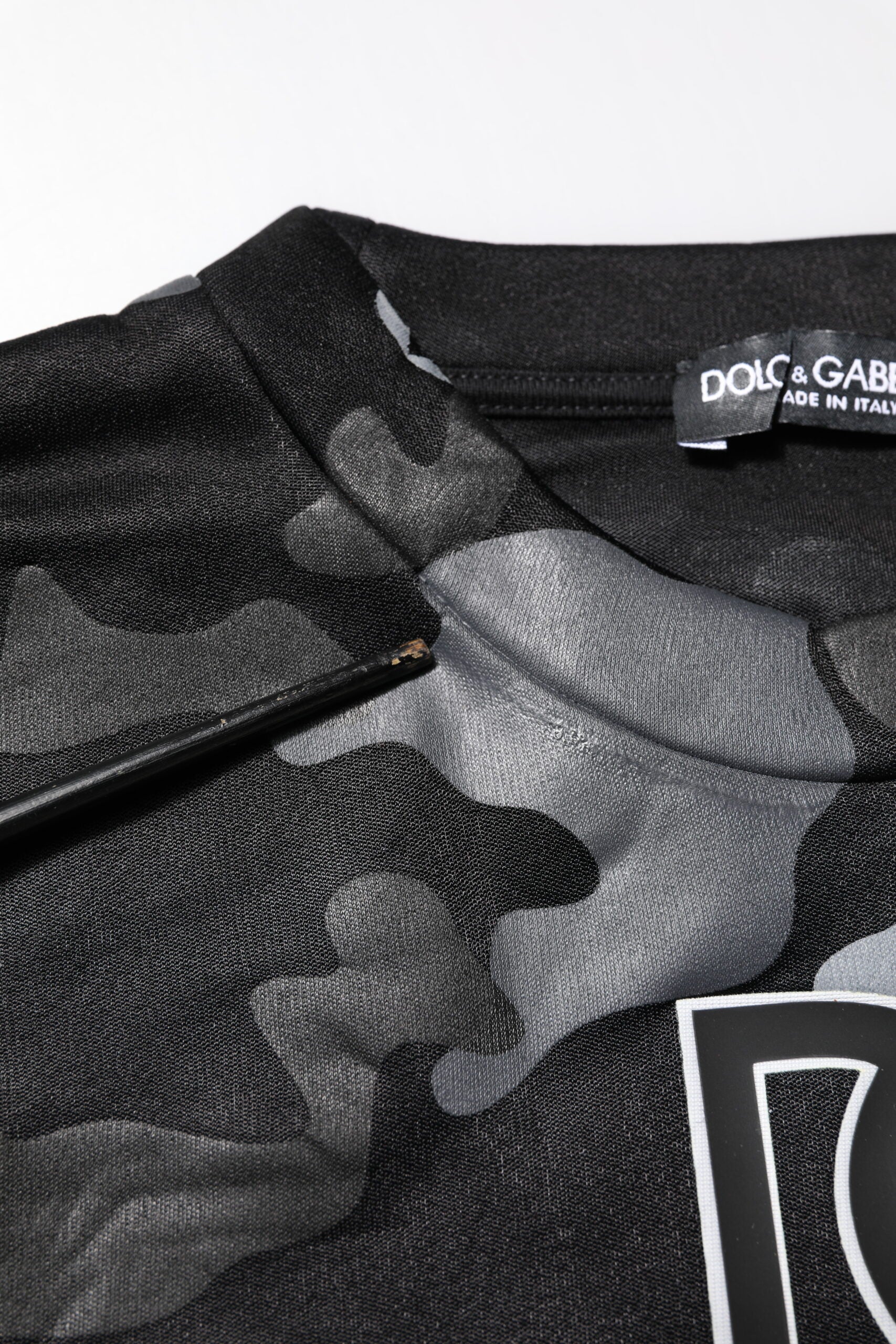 Black camouflage sports jersey with white logo on front