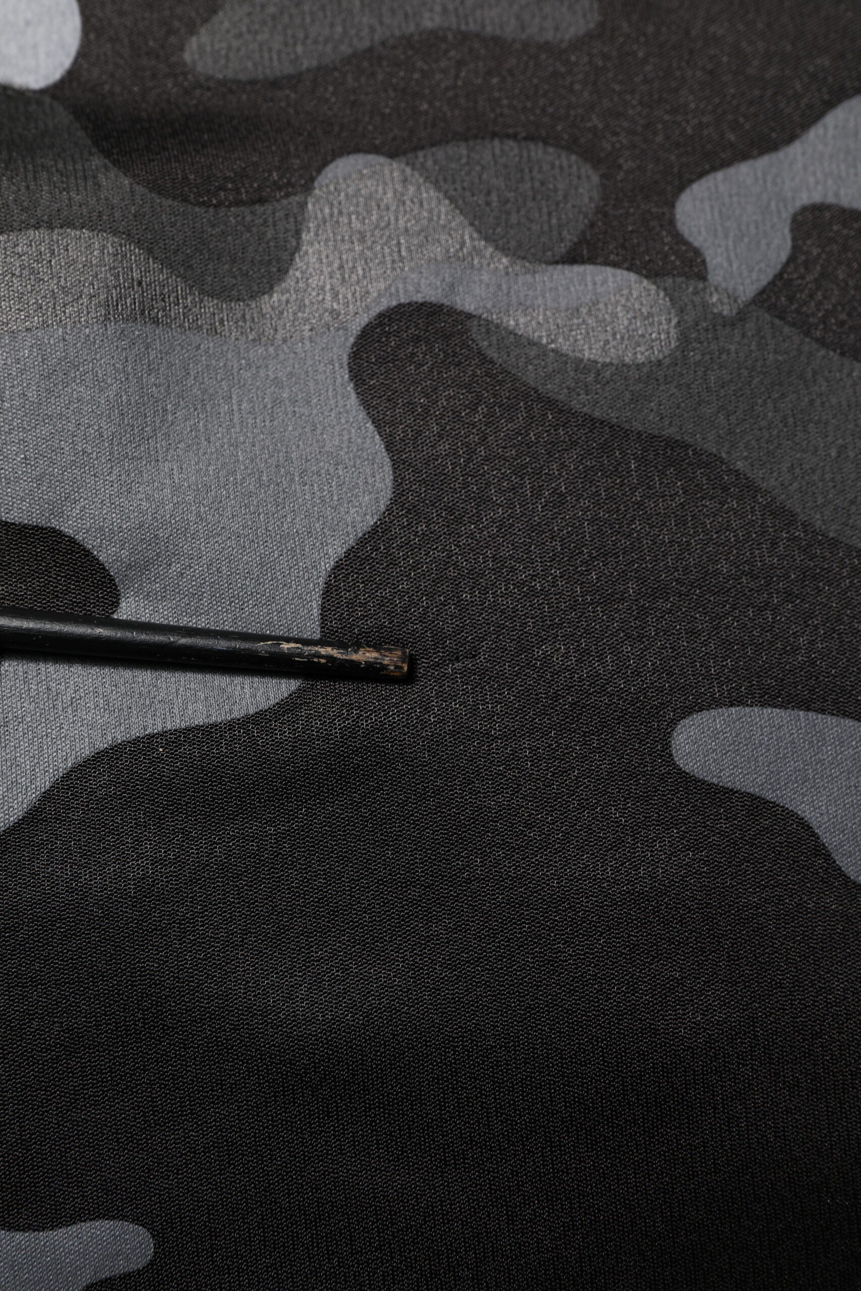 Camouflage fabric with a needle in it