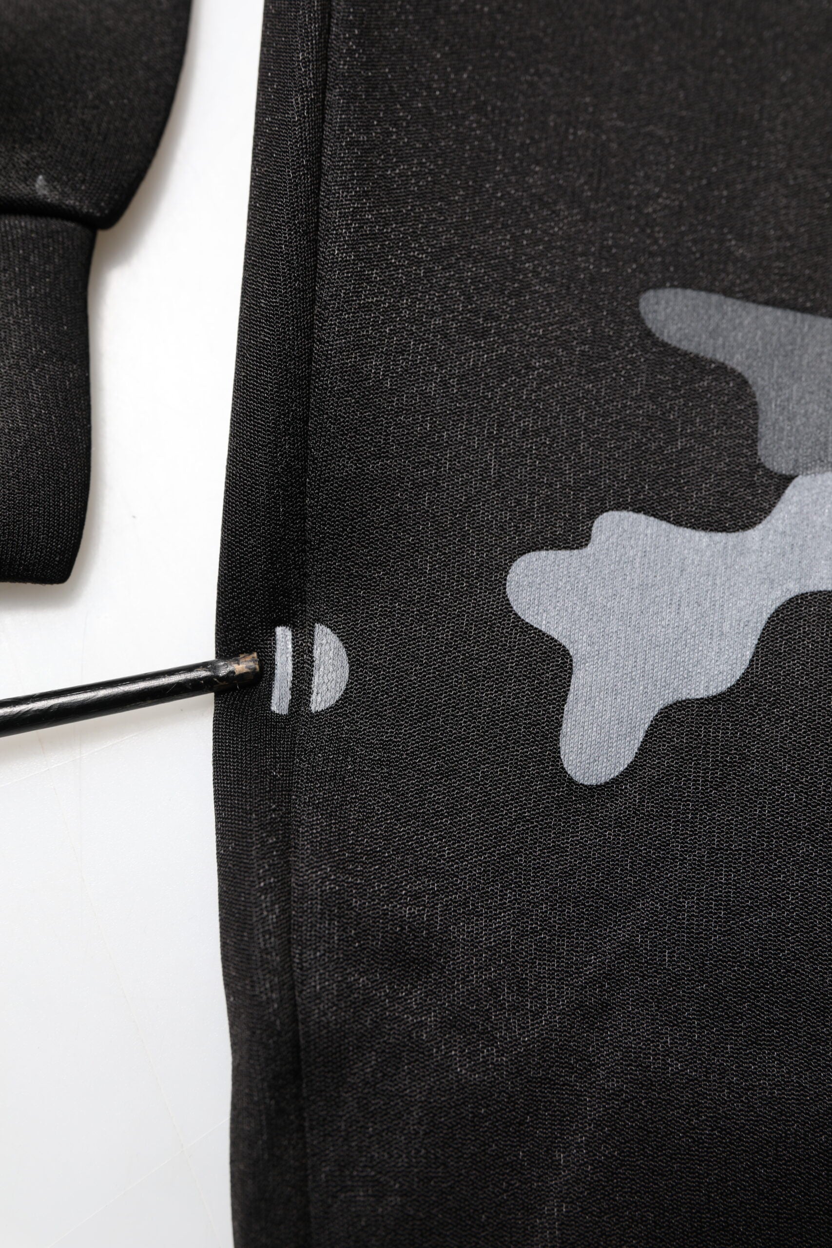 Black fabric with white camouflage pattern
