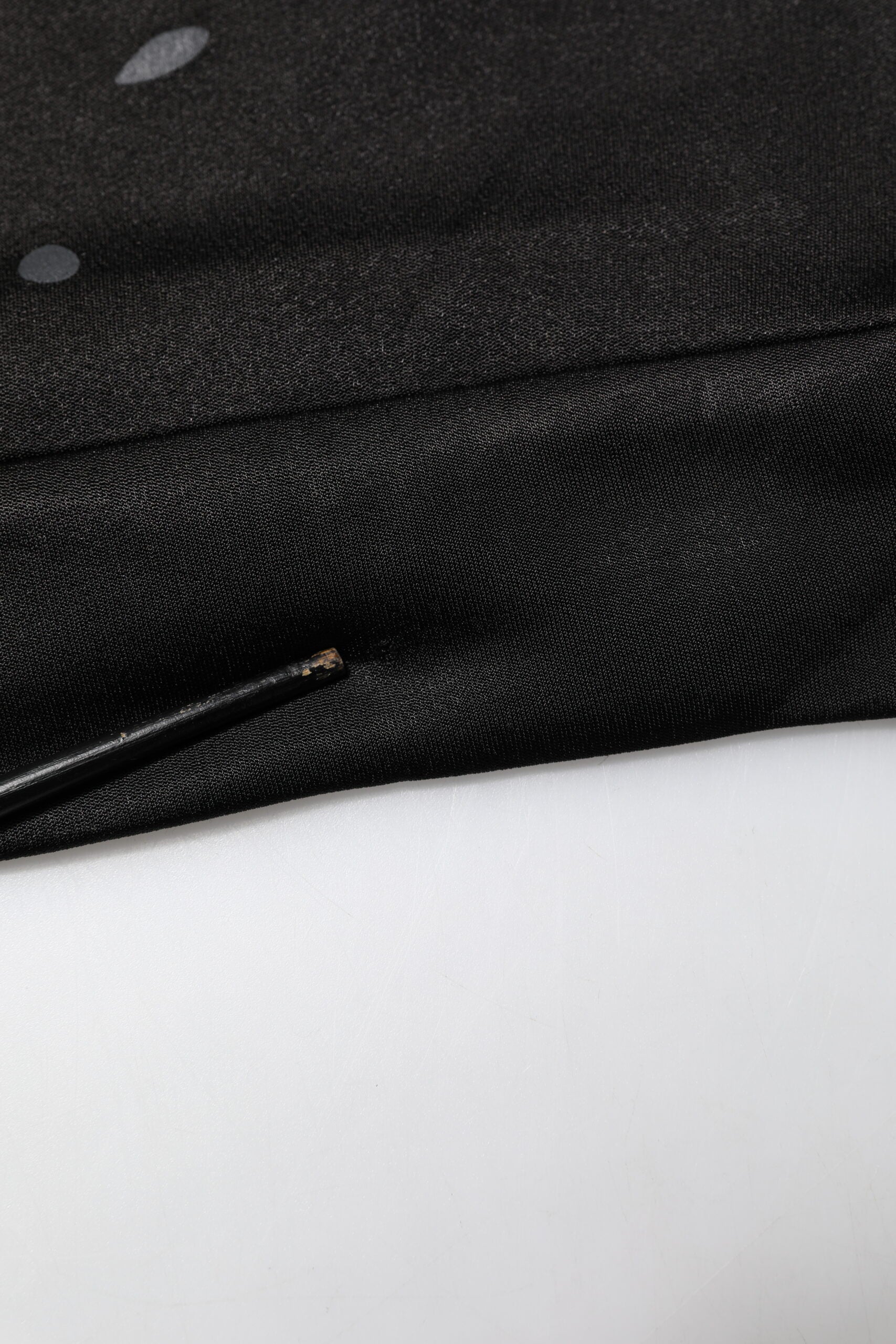 Black fabric with a small hole in the center