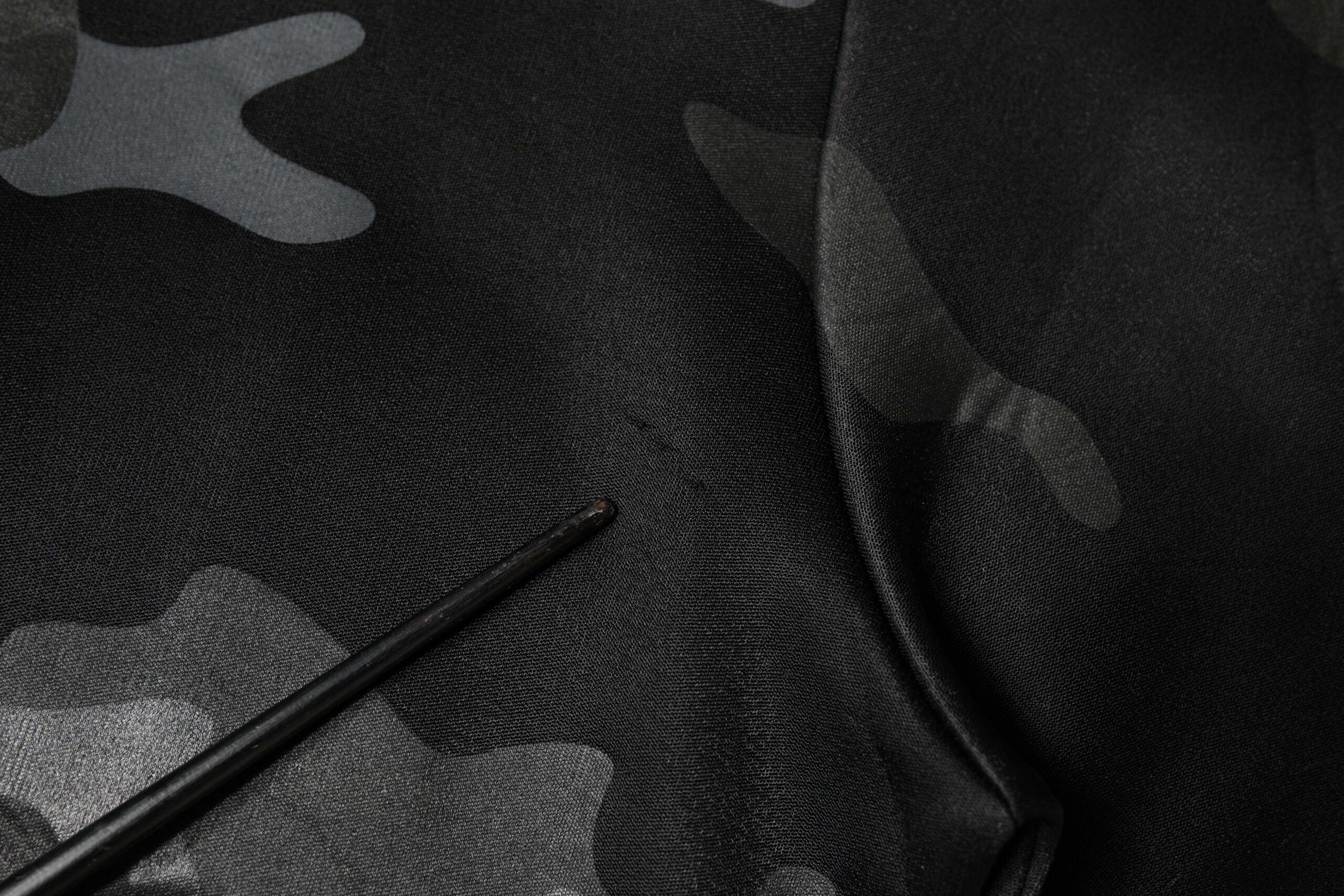 Black fabric with camouflage pattern