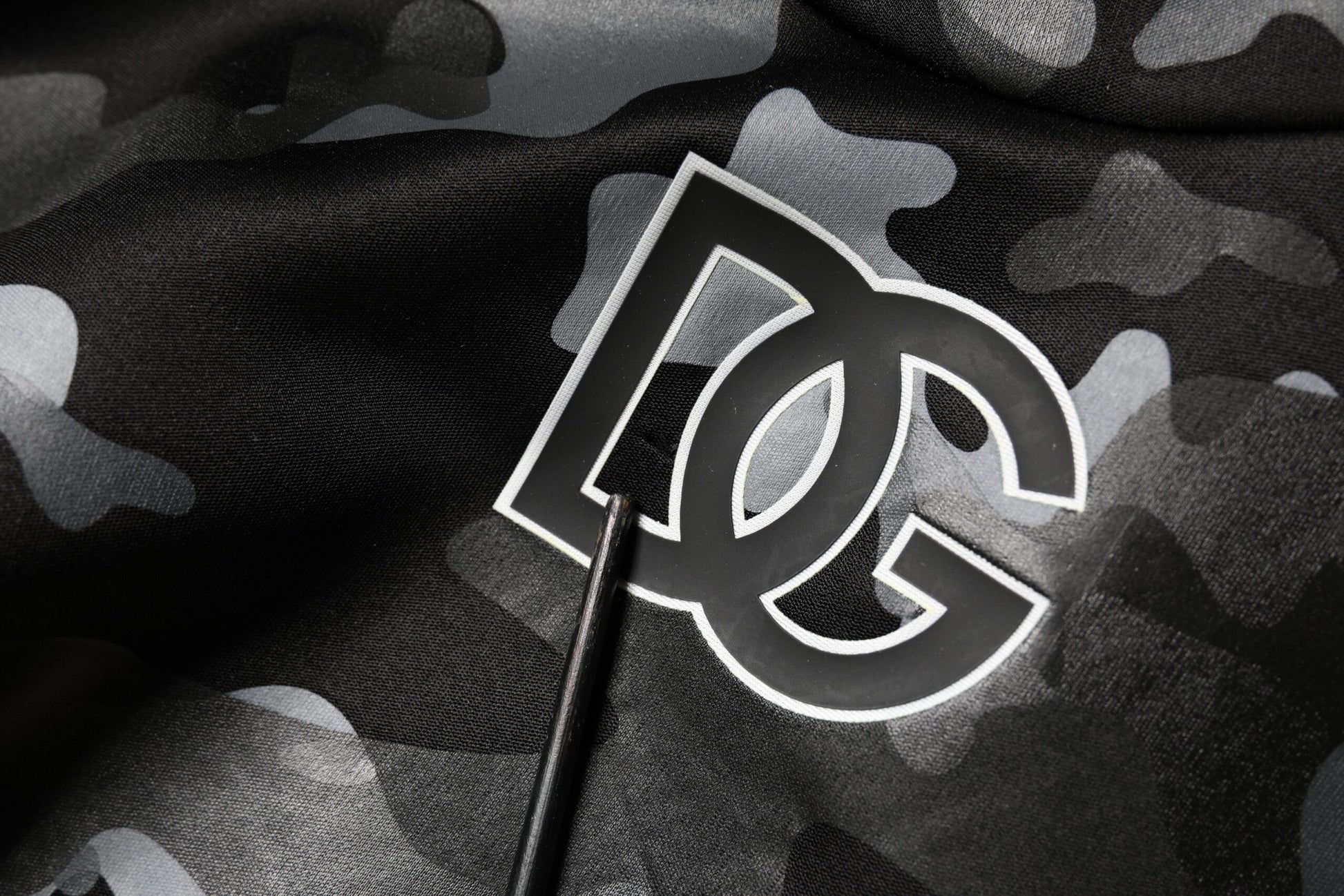 Camouflage fabric with embroidered DC logo