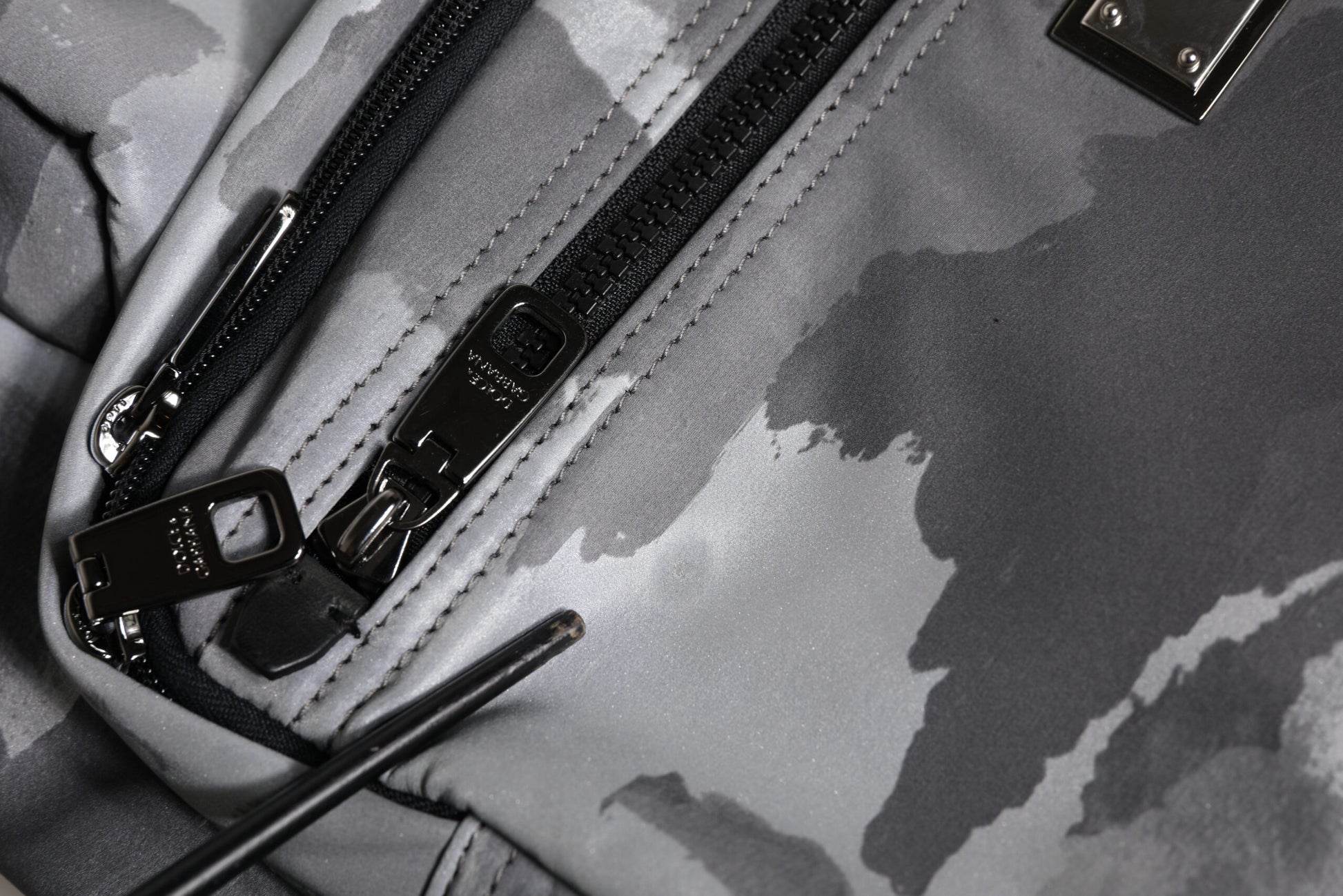 Camouflage backpack with multiple pockets and zippers