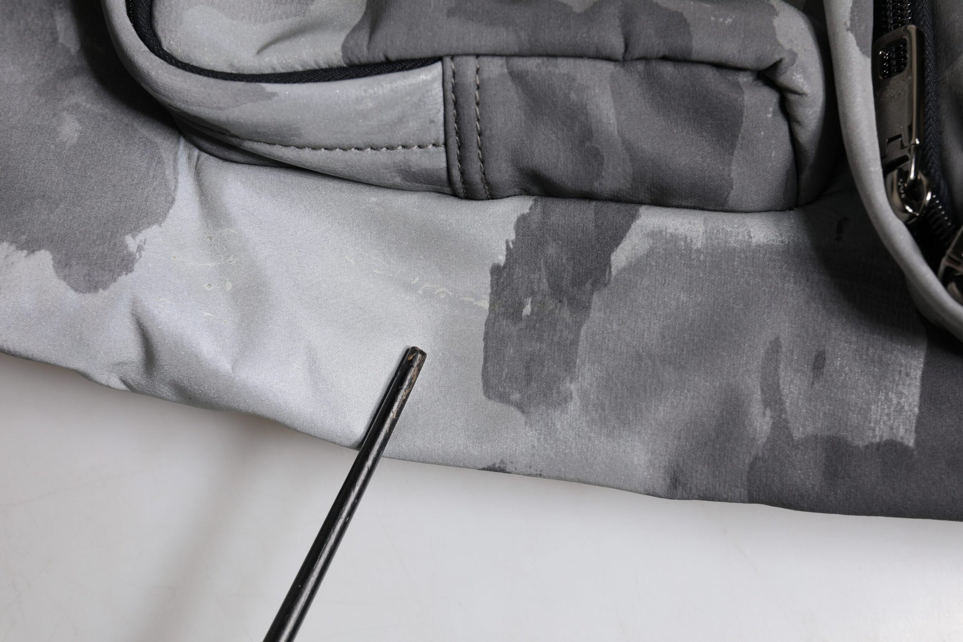 Grey jacket with camouflage pattern on sleeve