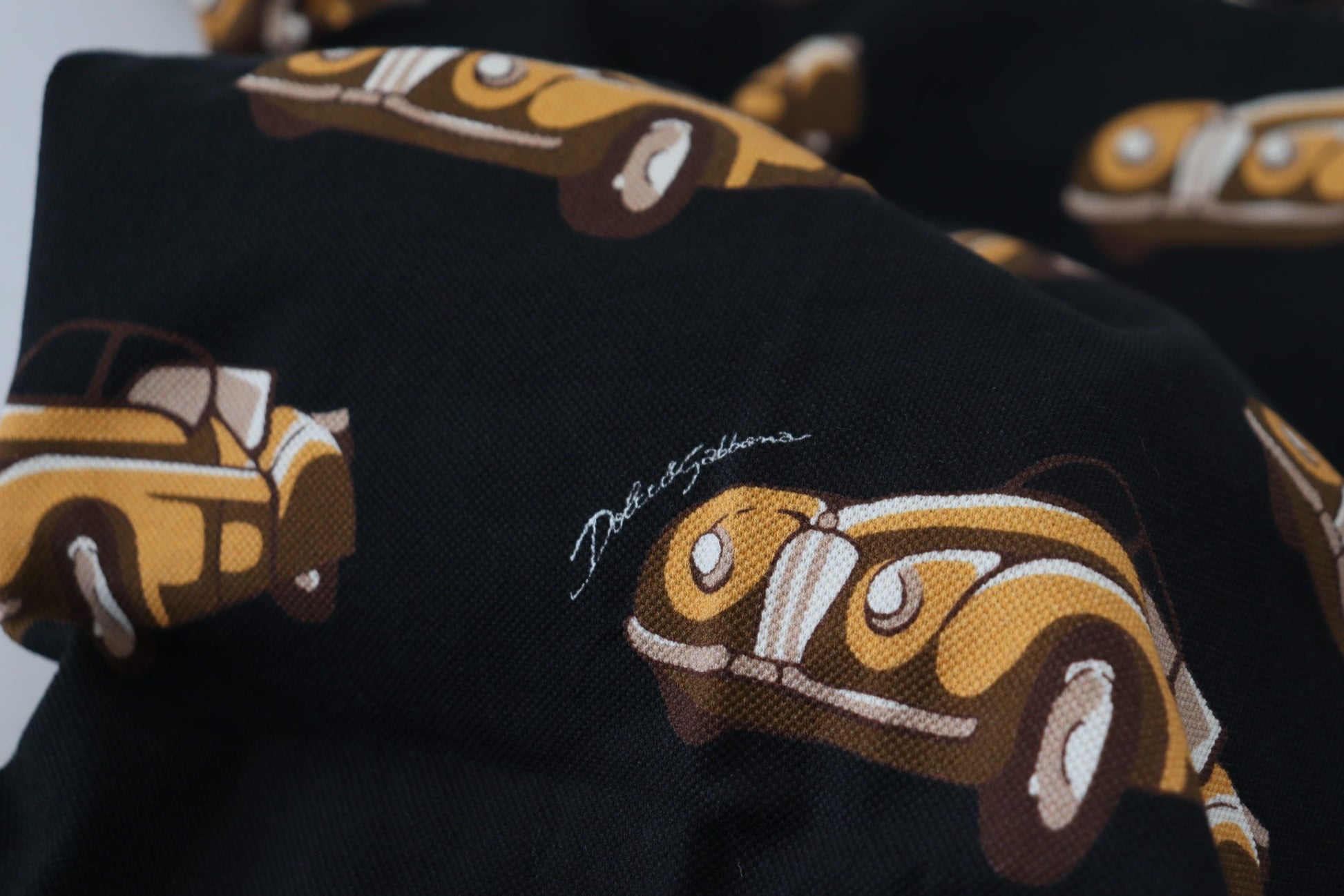 Black fabric with yellow cars pattern