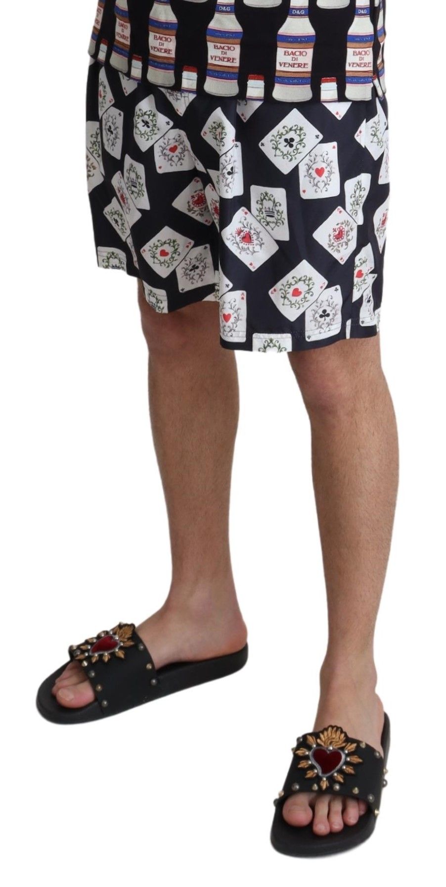 Man wearing shorts with playing cards pattern and sandals