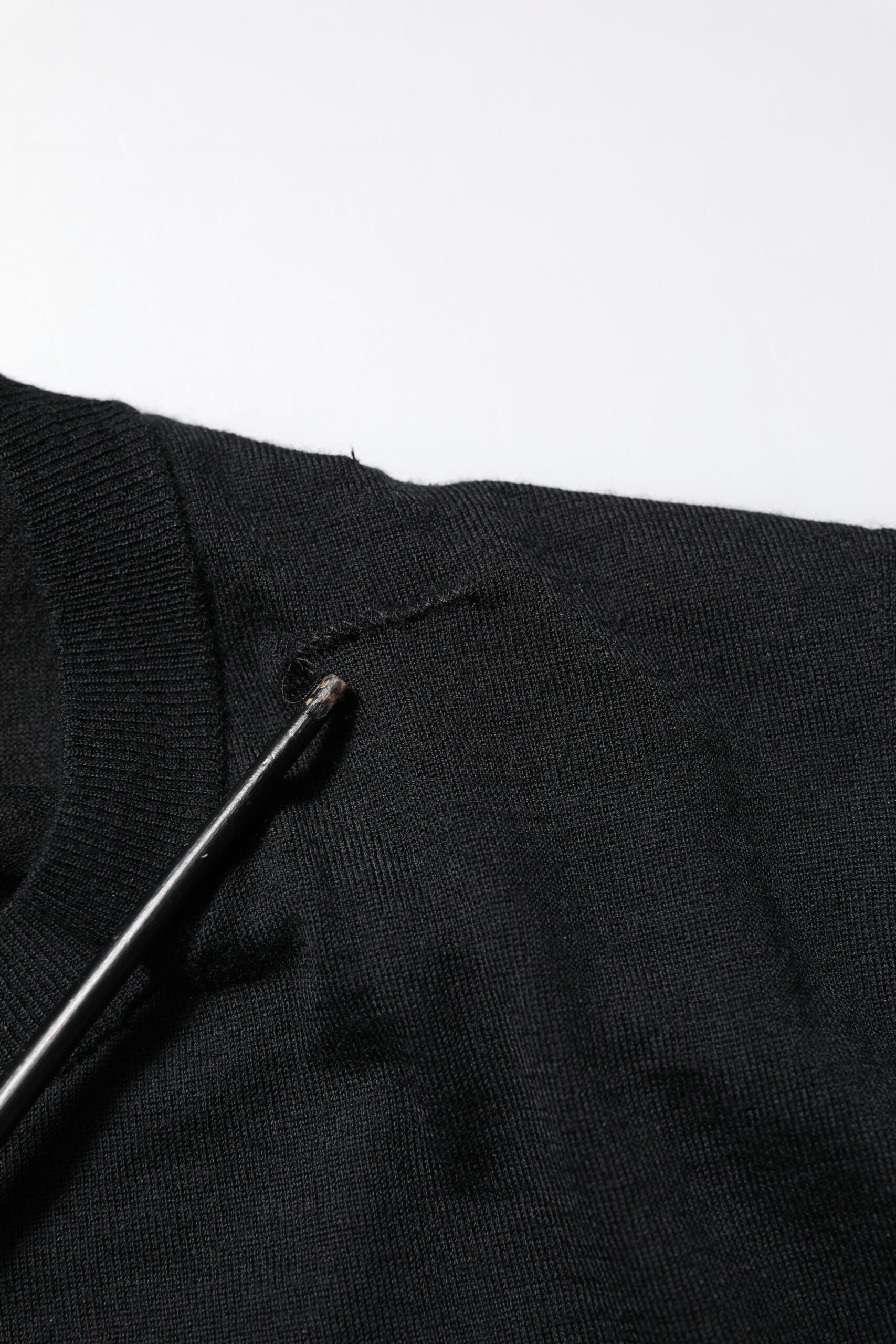 Black fabric with a small black object on top