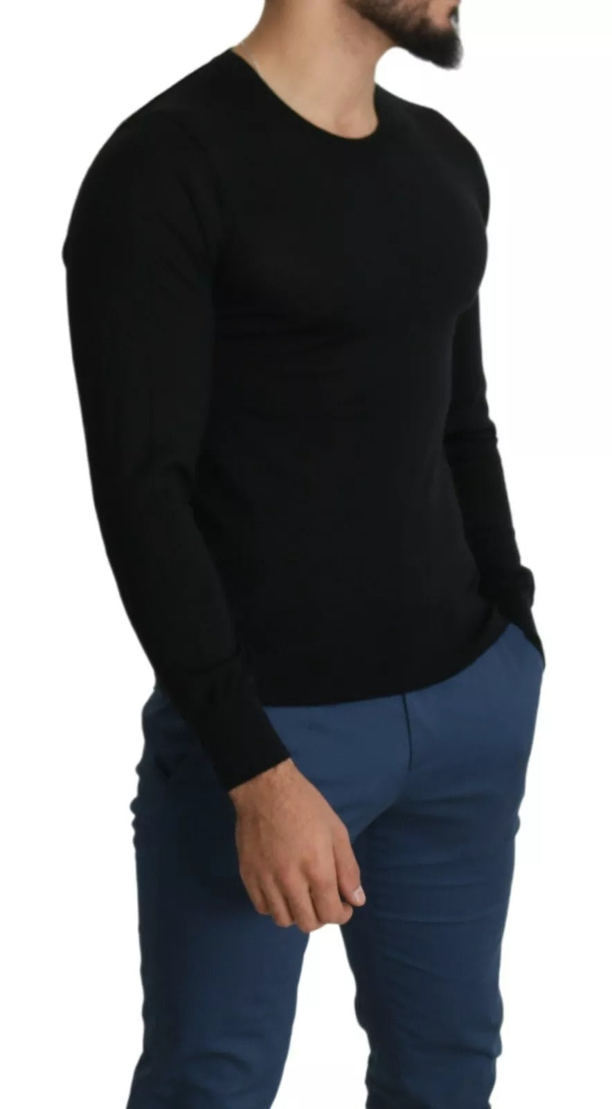 Man wearing black shirt and blue pants standing against white background