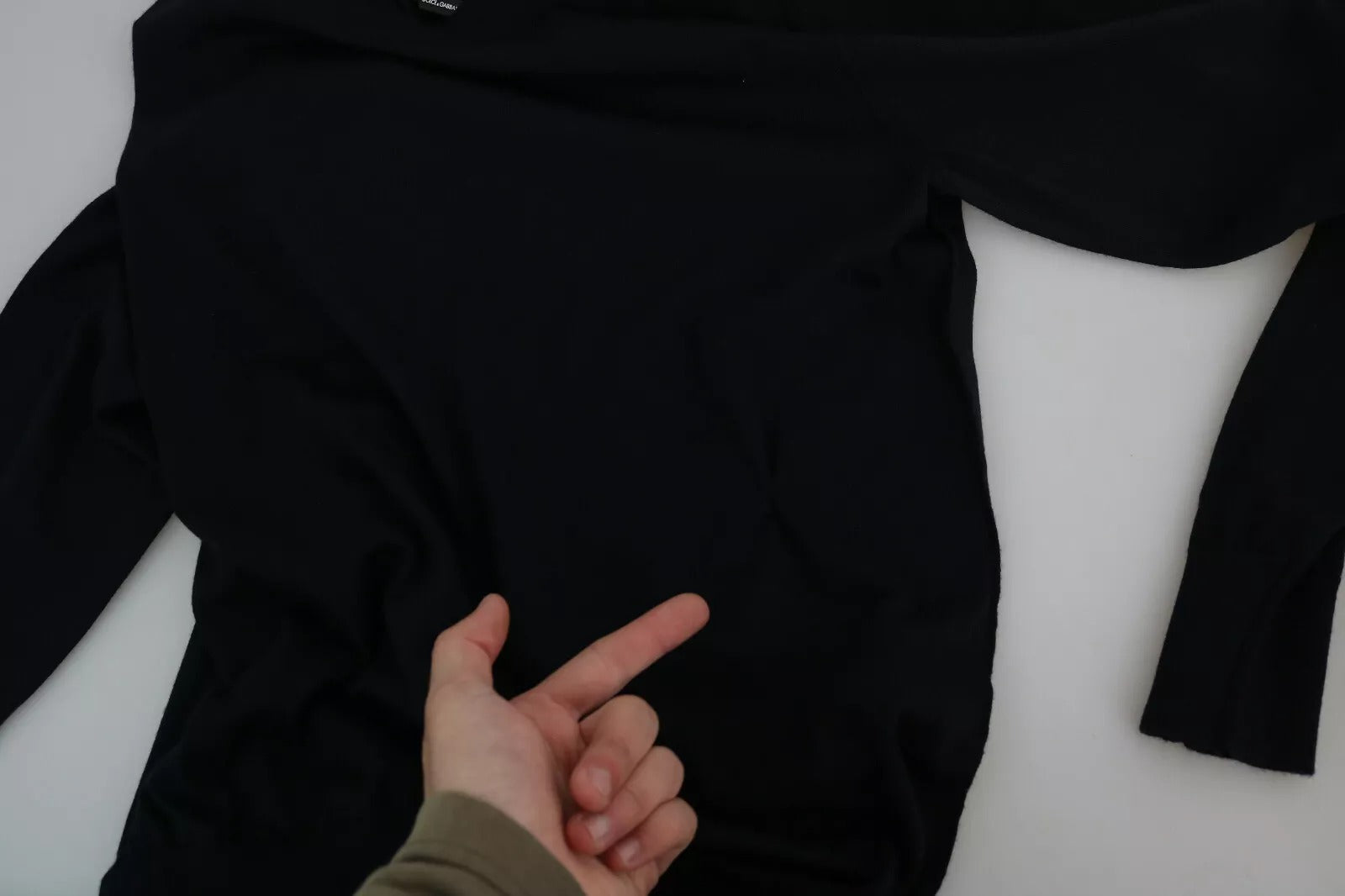 Black long sleeve shirt on hanger