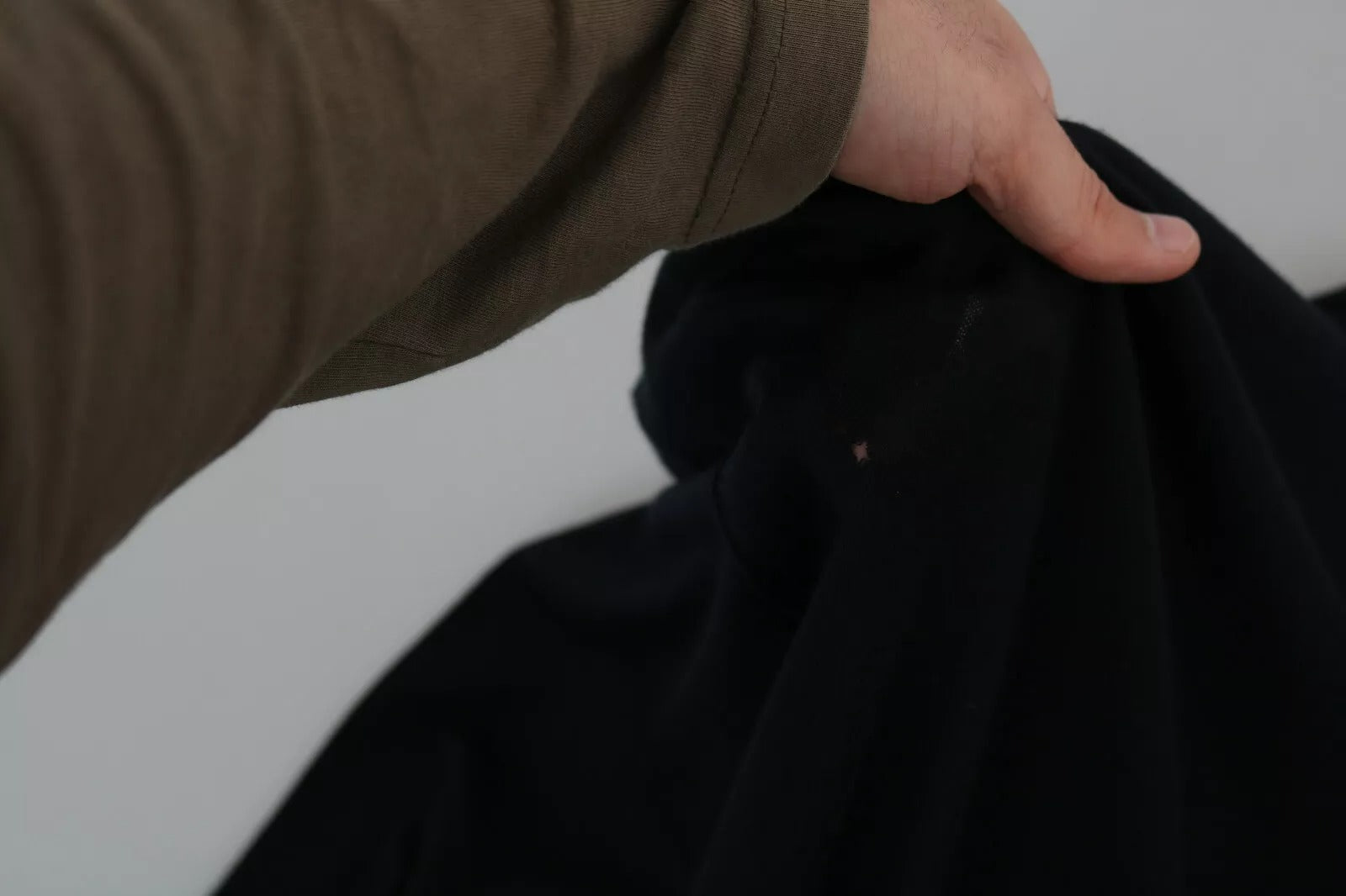 Man holding black cloth in hand