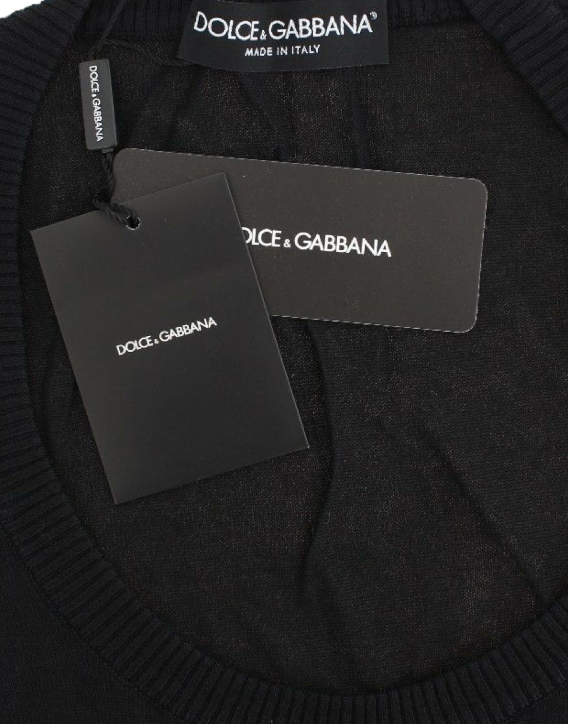 Black sweater on hanger with tags