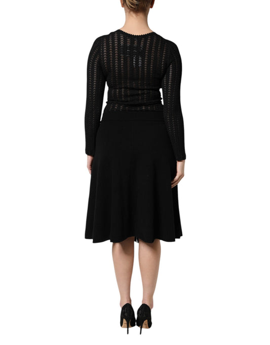 A black cashmere midi dress with long sleeves and an A-line skirt