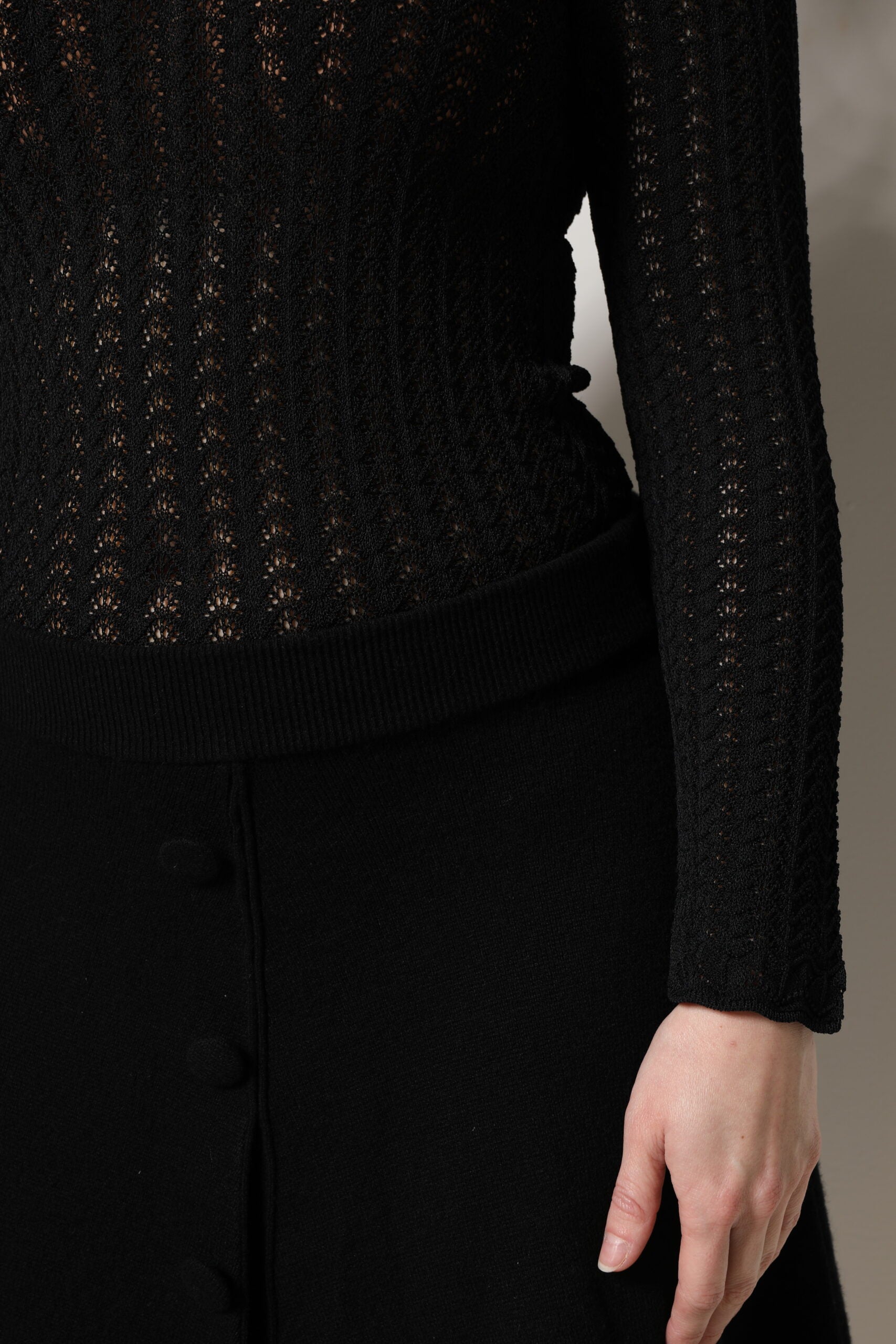 A black cashmere long sleeve midi dress with lace detailing on the bodice