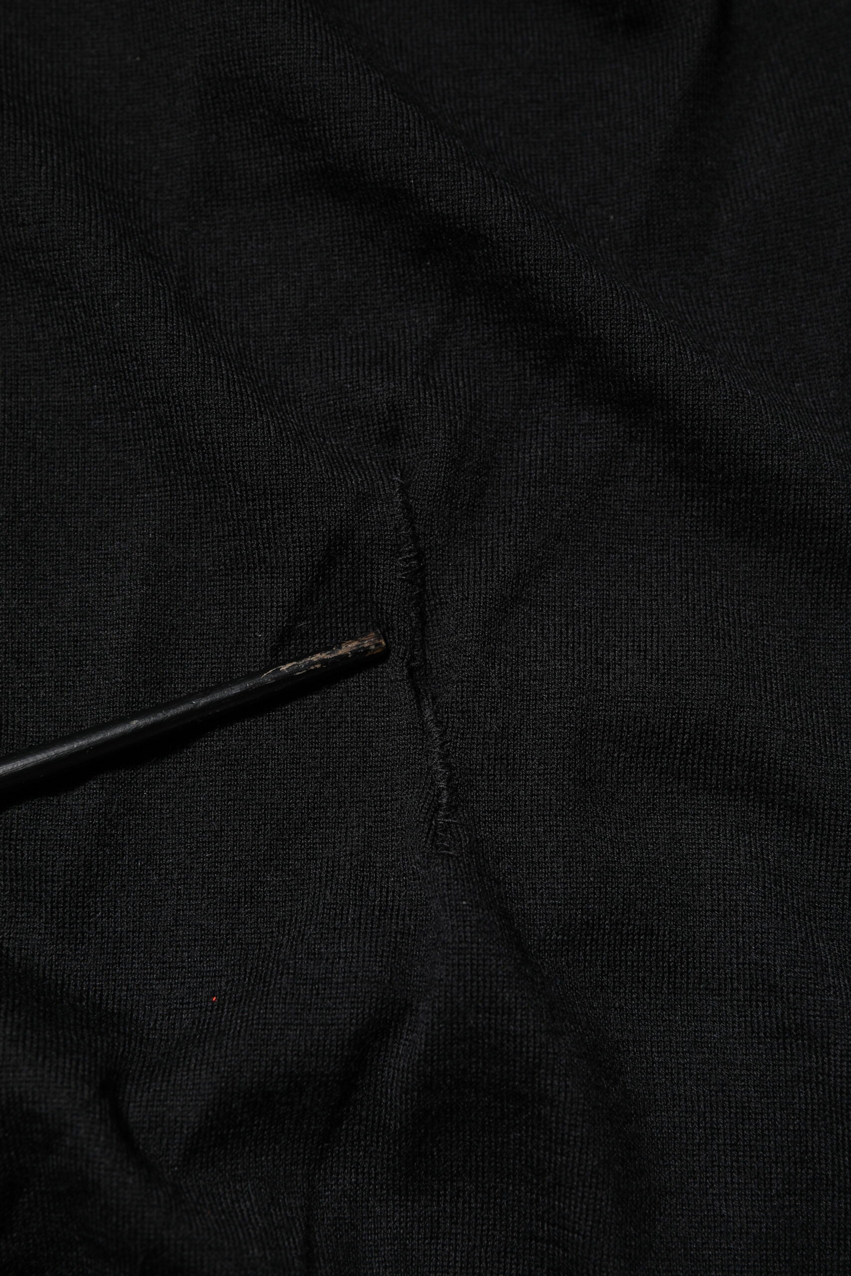 Black fabric with a small hole in it