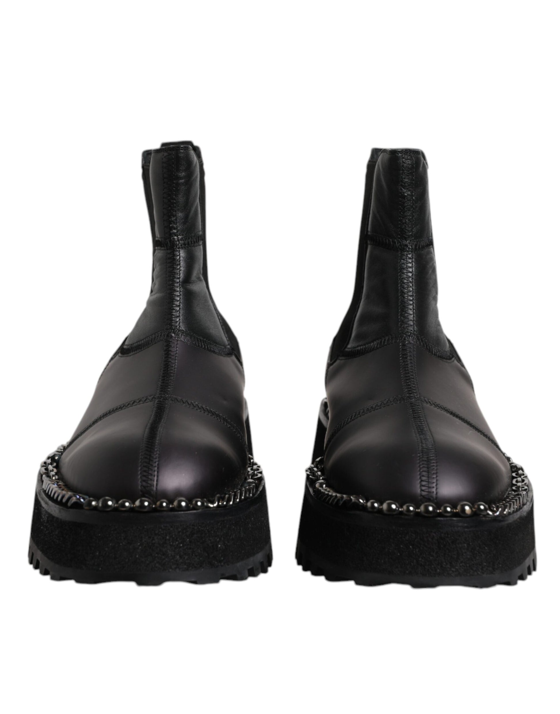 Pair of black leather boots with silver studs on sides