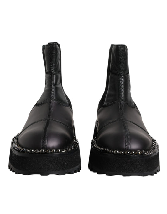 Pair of black leather boots with silver studs on sides