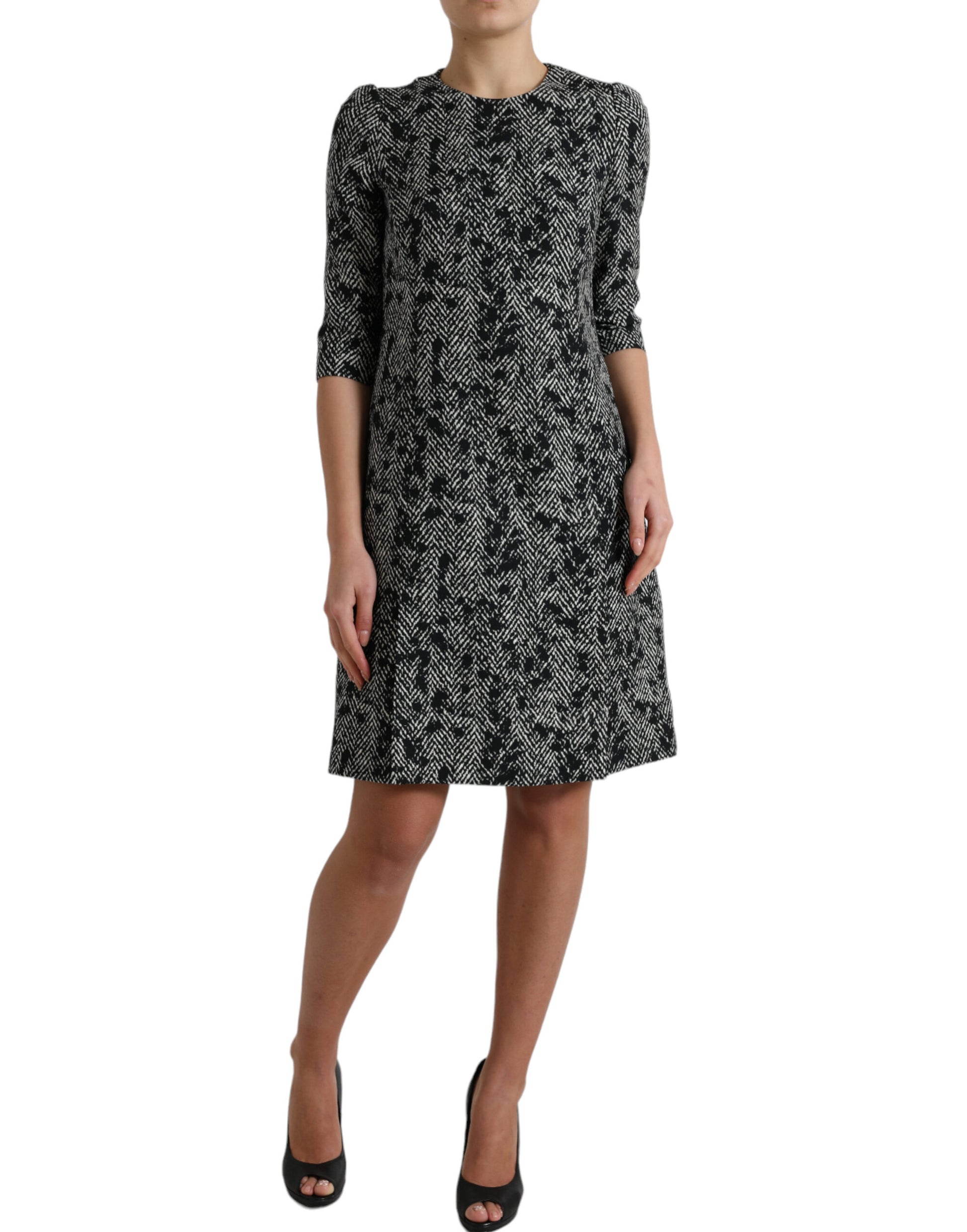 A black chevron patterned dress with short sleeves and a knee-length skirt