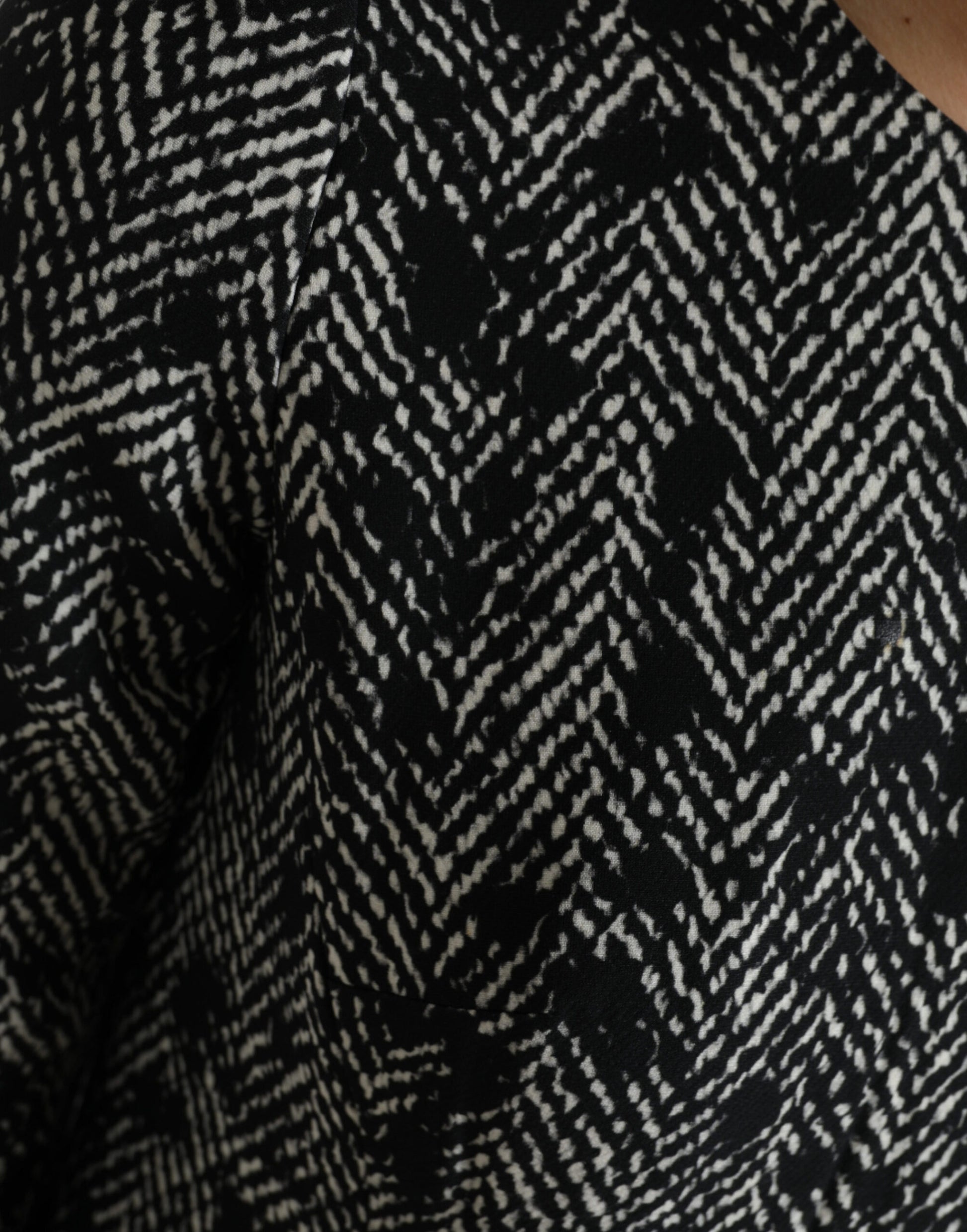 A black chevron patterned dress with a V-neckline and short sleeves