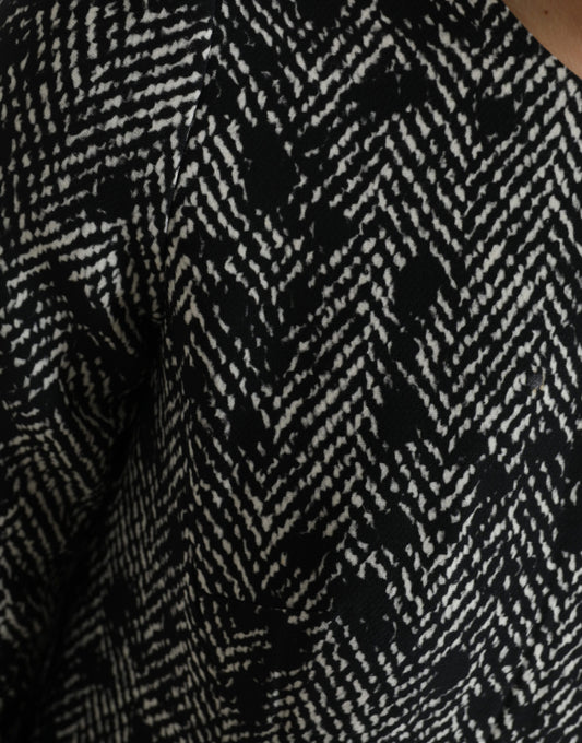 A black chevron patterned dress with a V-neckline and short sleeves