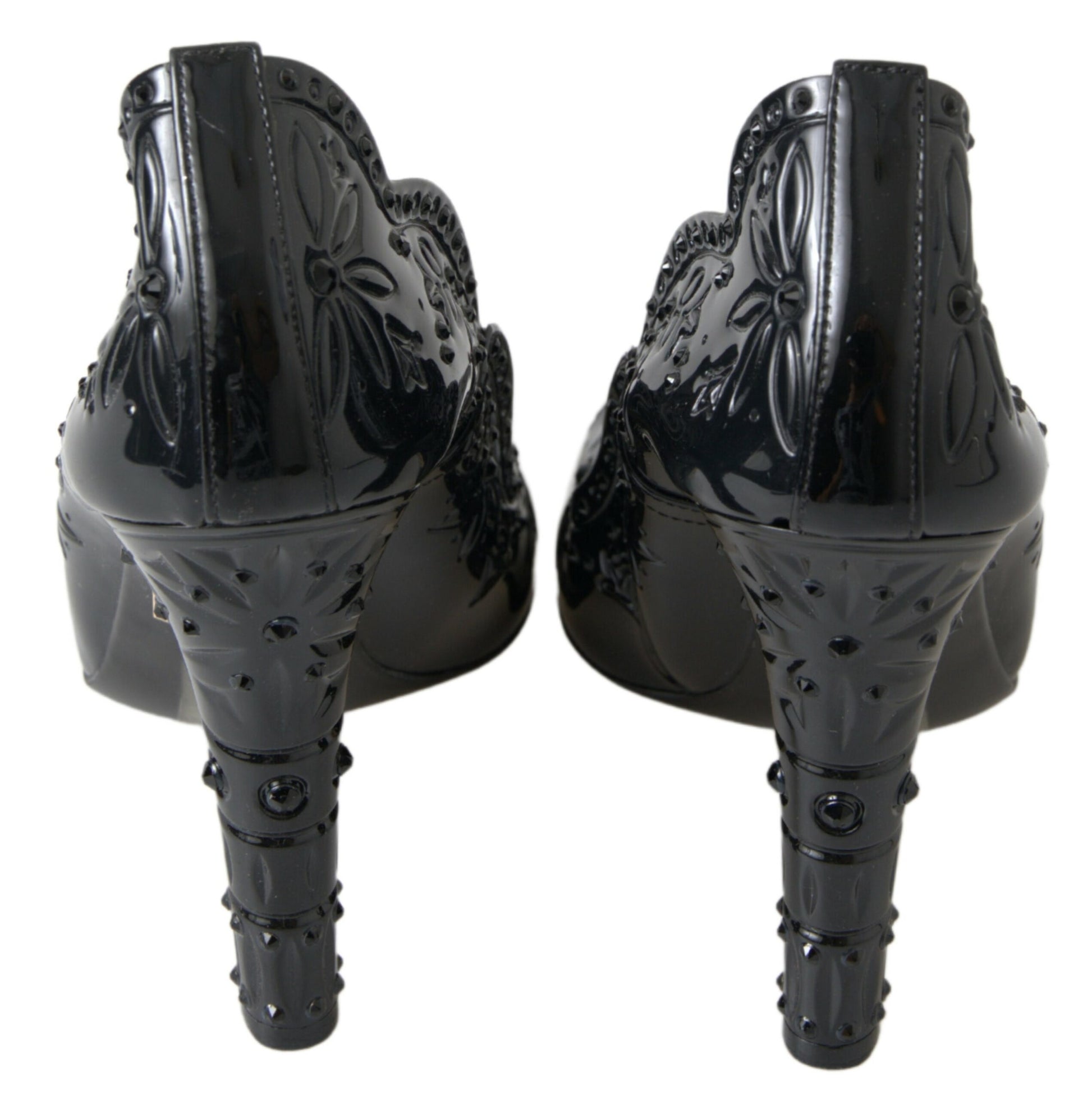 Pair of black high heel shoes with decorative designs on top and bottom