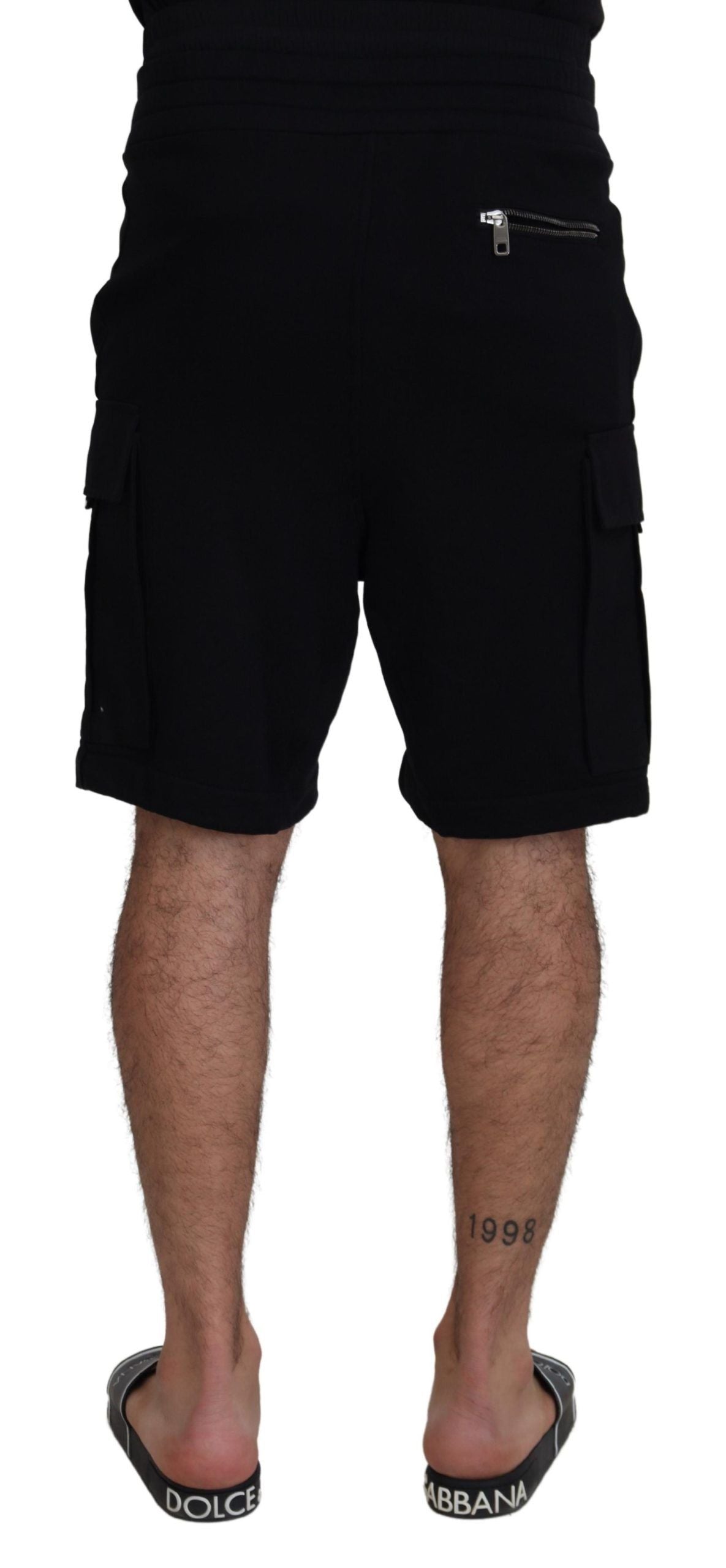 Man wearing black shorts and flip flops