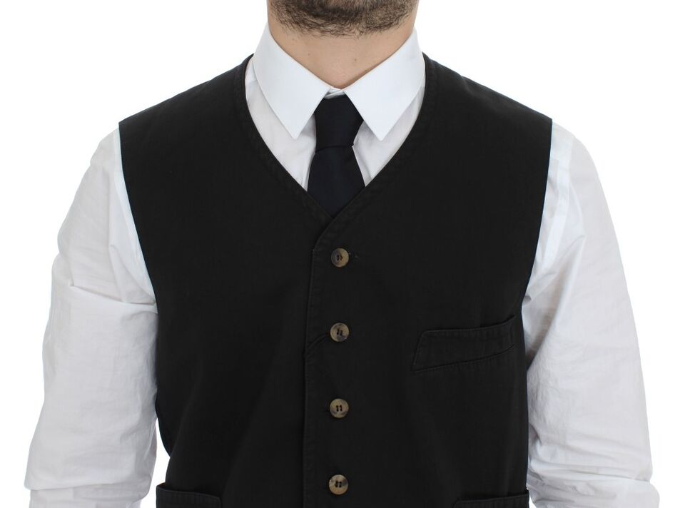 A black vest with a buttoned front and two pockets on the chest
