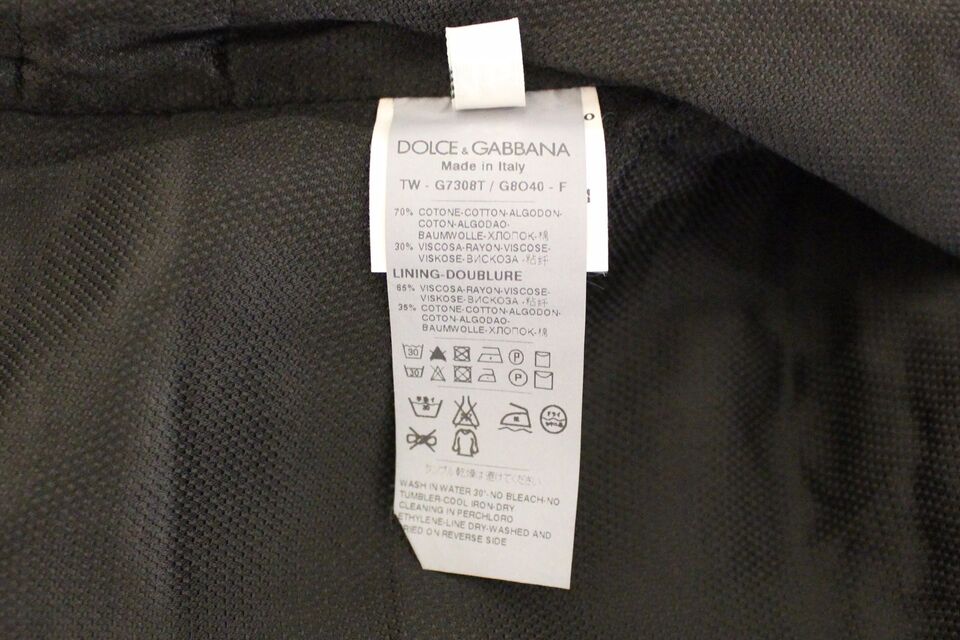 A black cotton blend vest gilet with a tag attached to it