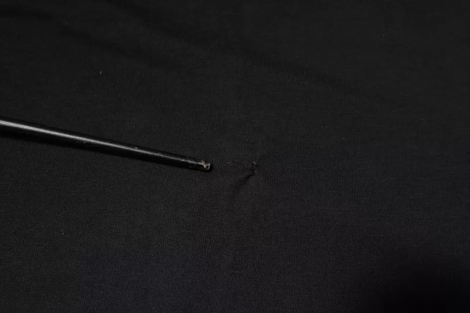 Black pen lying on black surface