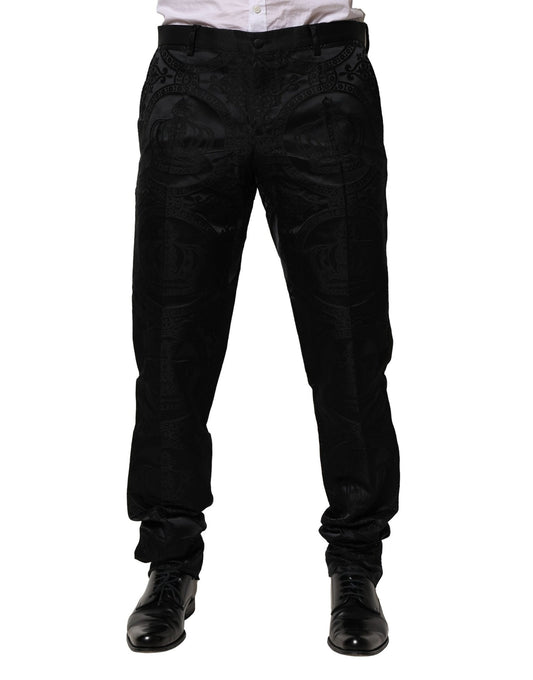 A pair of black cotton dress pants with a crown logo on the waistband