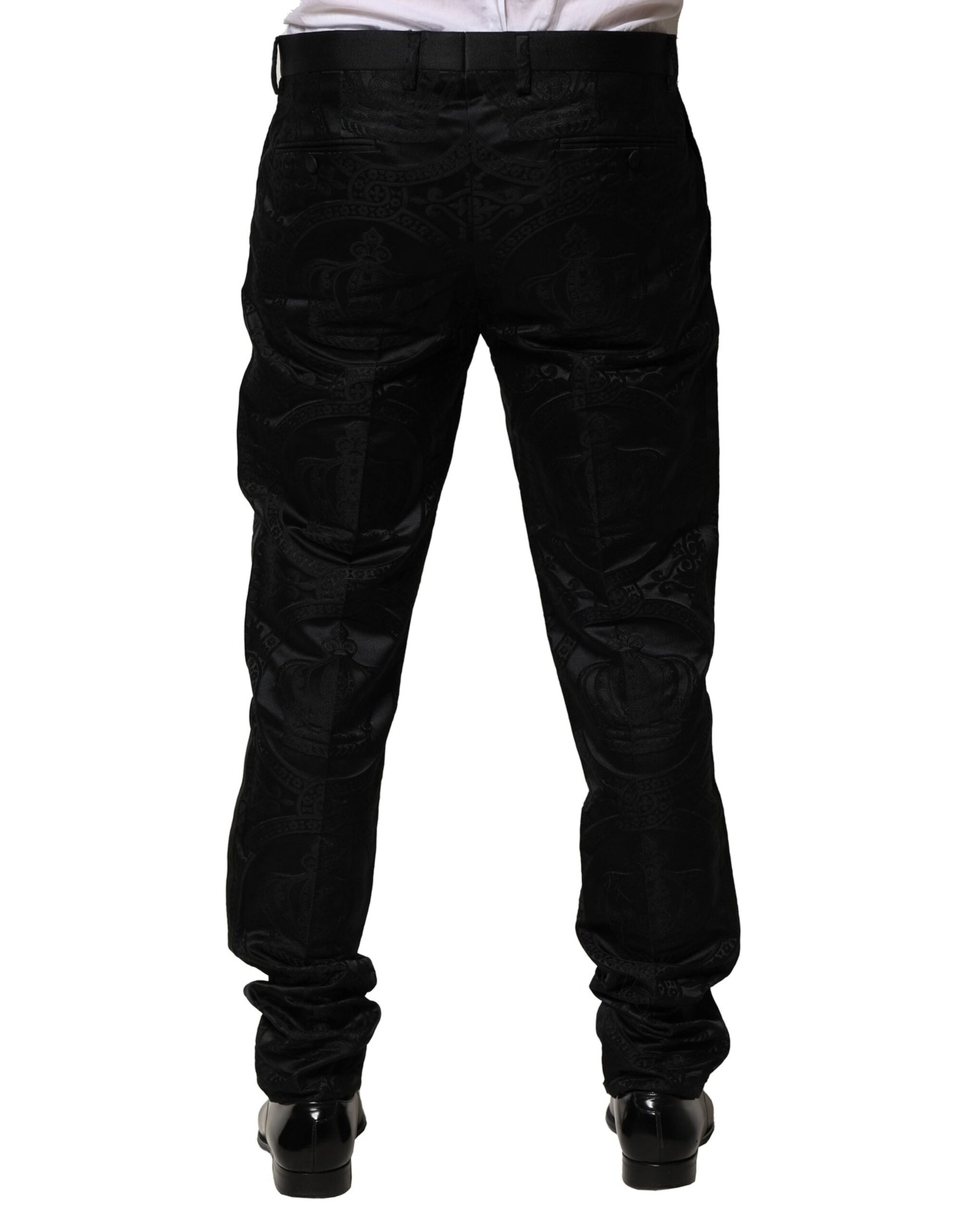 A pair of black cotton dress pants with a crown logo on the waistband