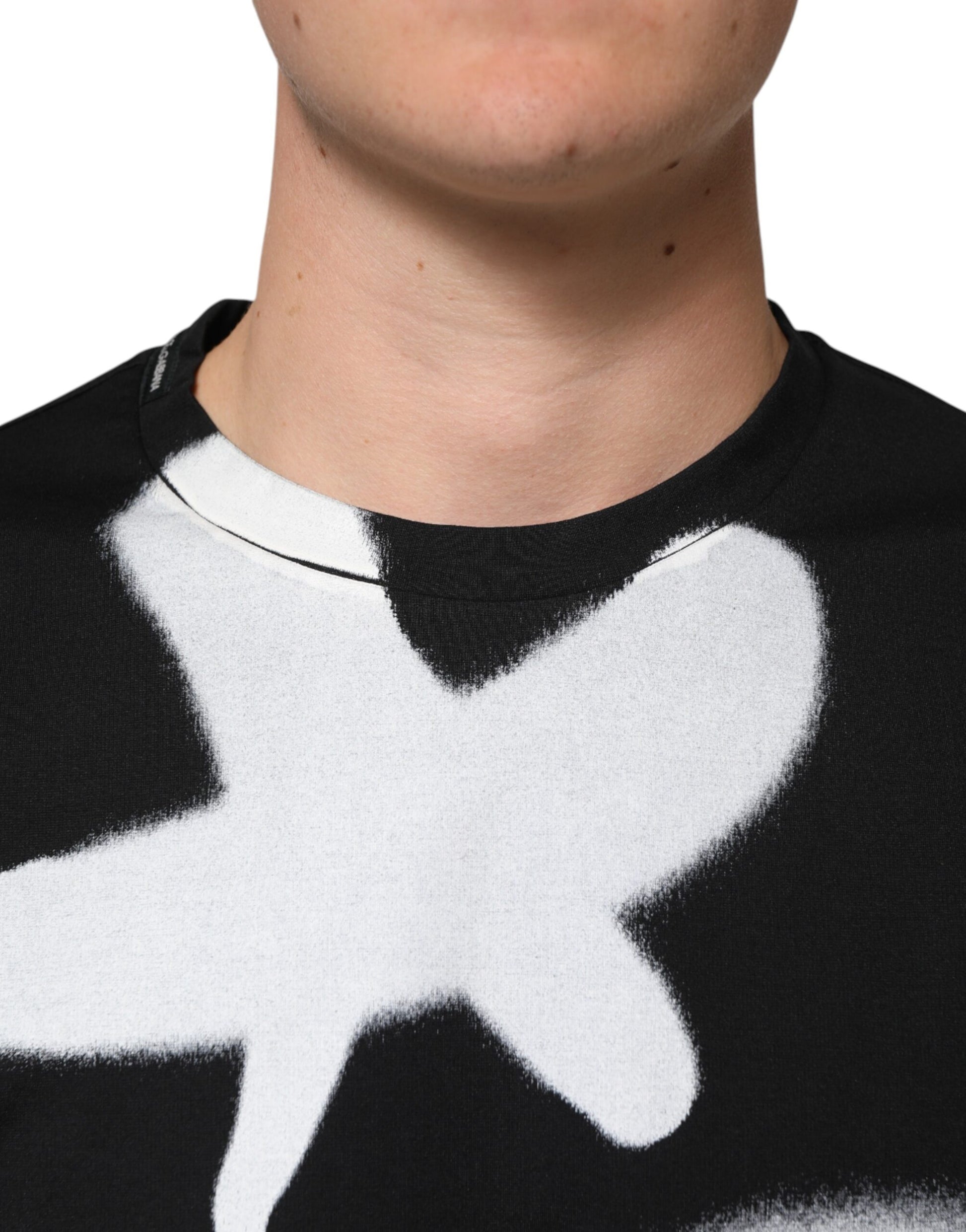 Man wearing black and white shirt with graphic design on front