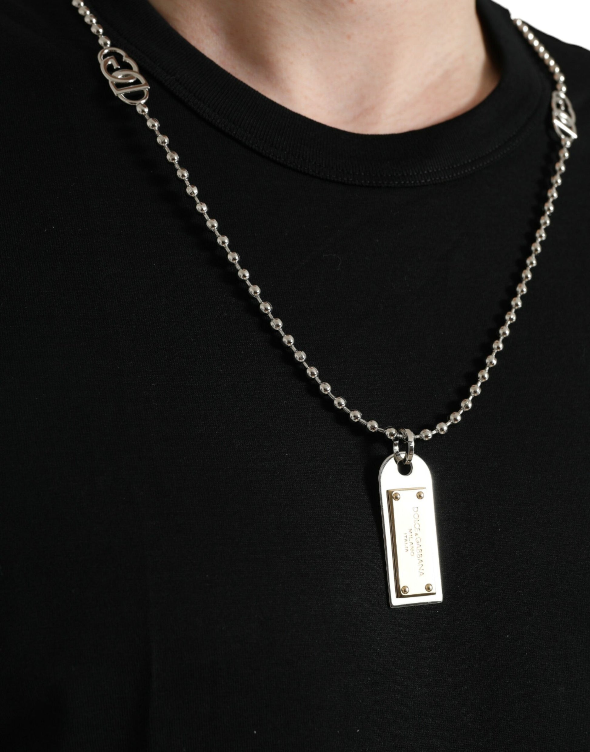 Silver chain necklace with a gold pendant