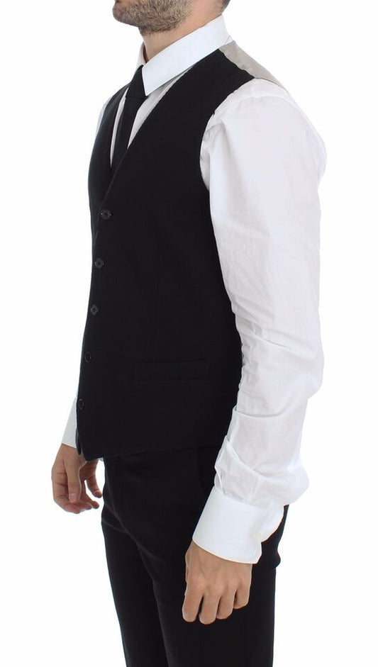 A black cotton vest jacket with a lapel collar, worn by a mannequin