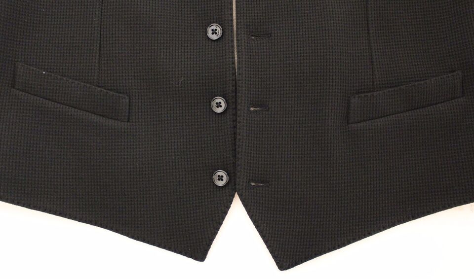 A black cotton vest jacket with two buttons and a pocket on the left chest