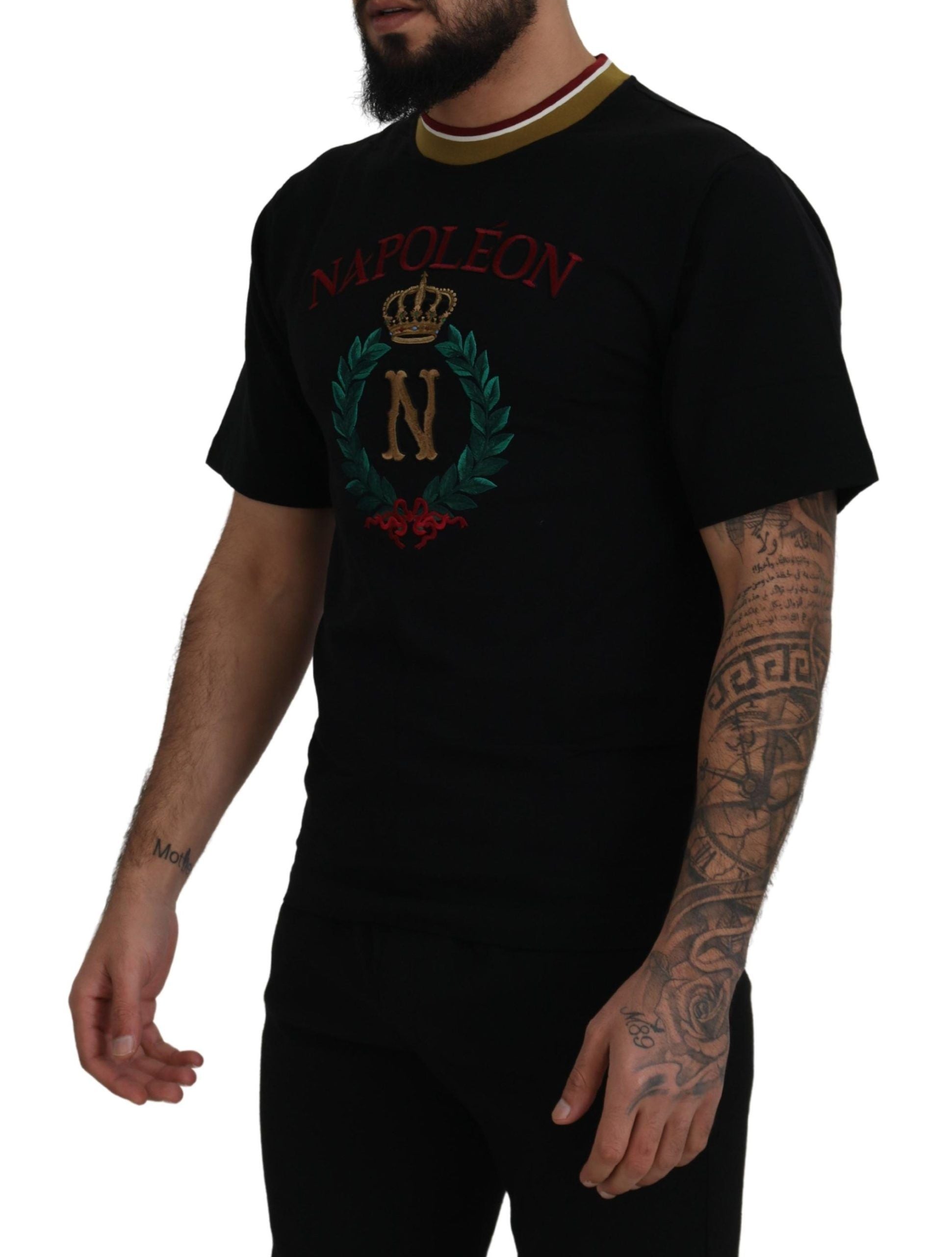 Man wearing black t-shirt with red lettering and gold crown logo