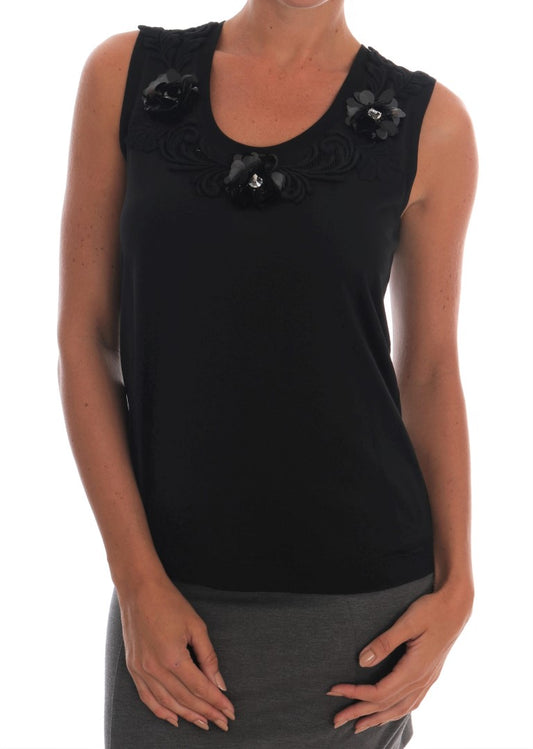 Black sleeveless top with embellishments on shoulders