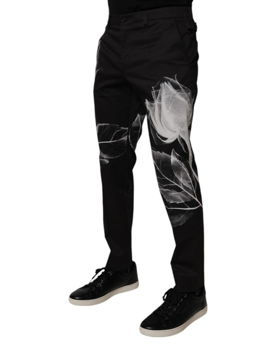 A pair of black cotton skinny dress pants with a floral pattern on the legs