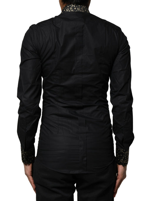 A black cotton dress shirt with long sleeves and gold accents