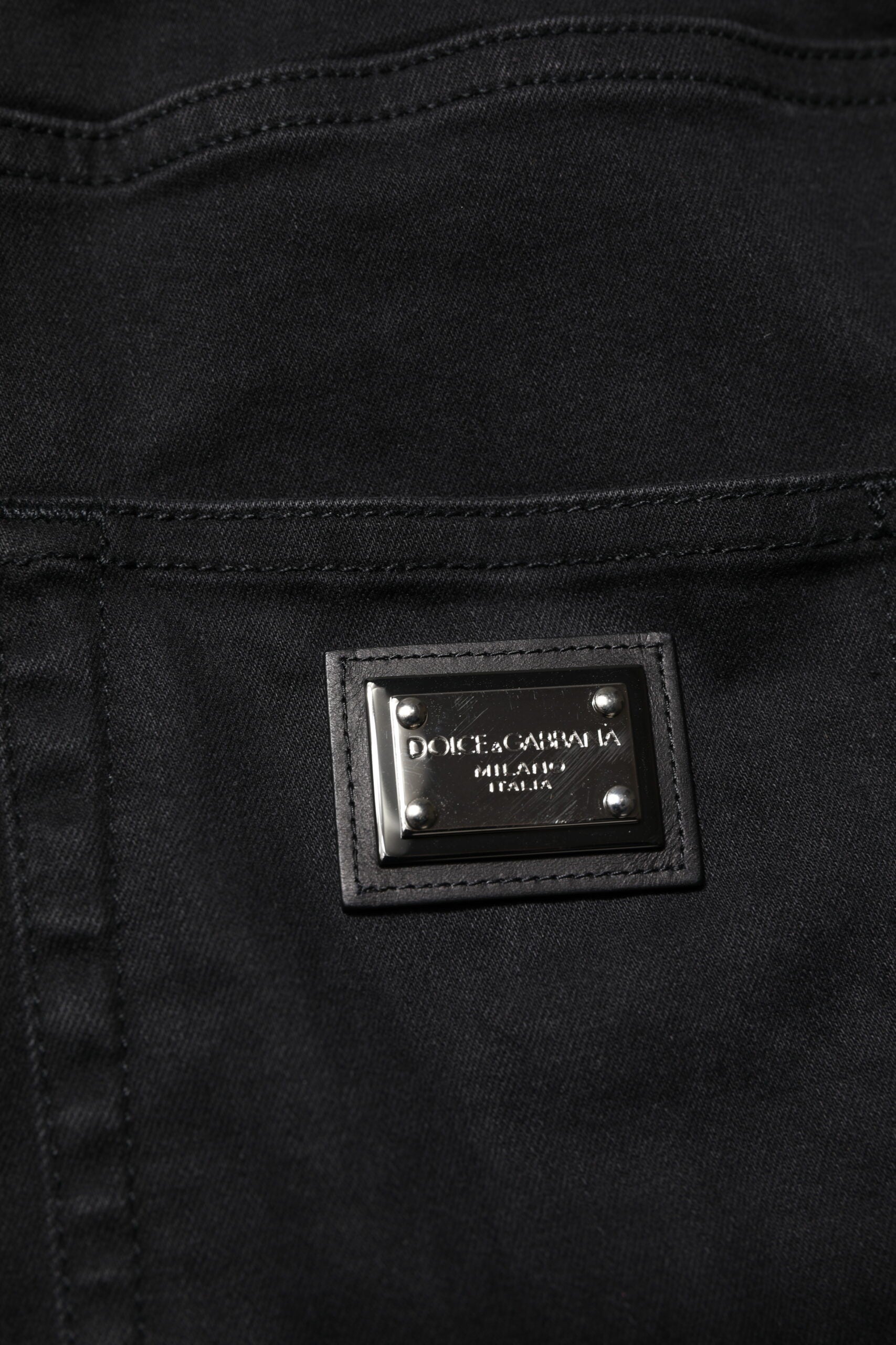 Black denim jeans with a label on the waistband
