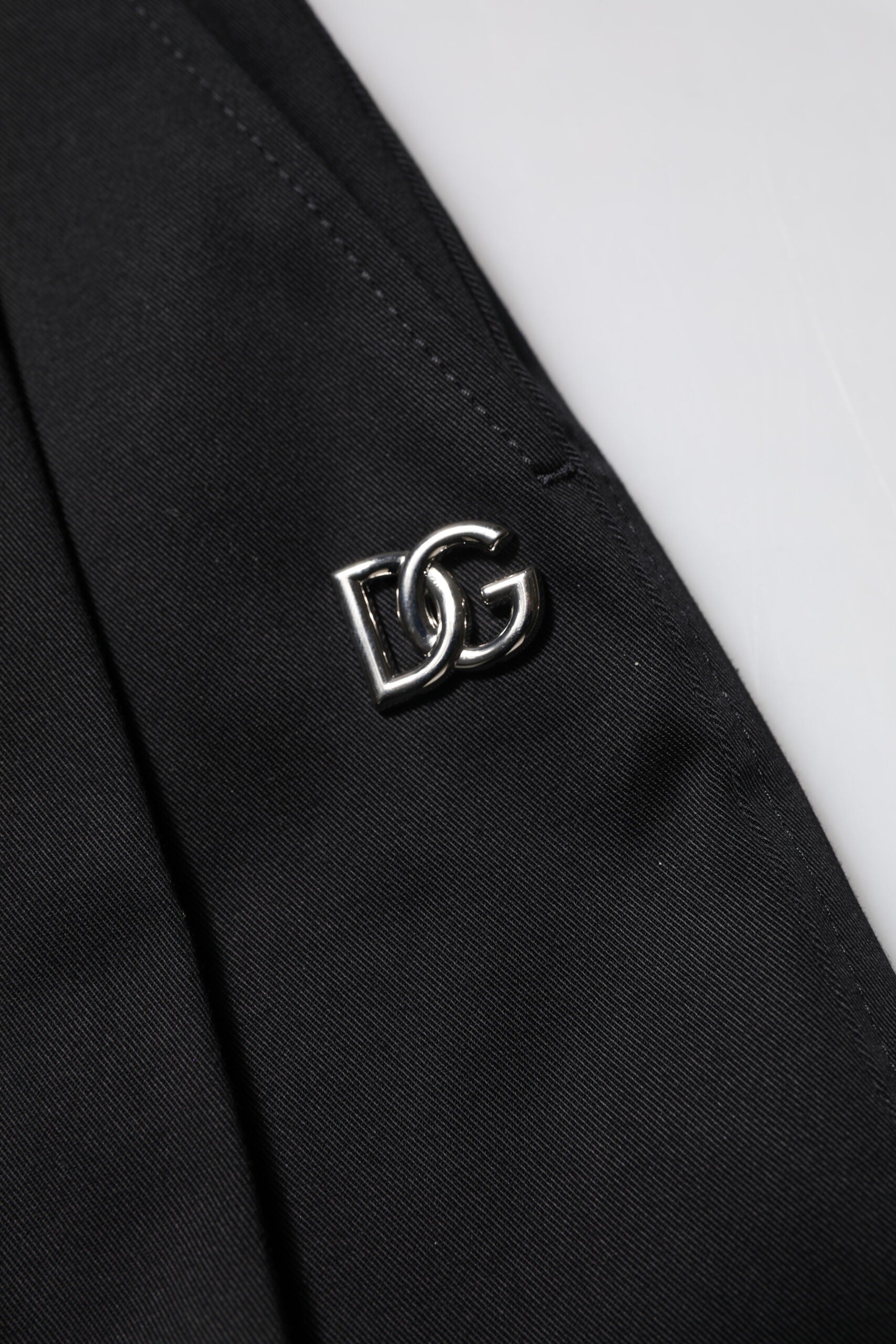 Black suit jacket with silver logo on lapel