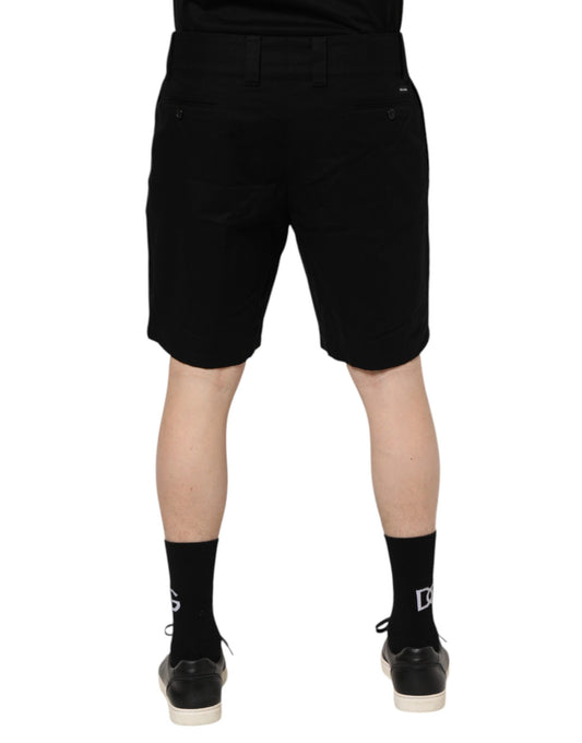 Black shorts on a person standing against white background