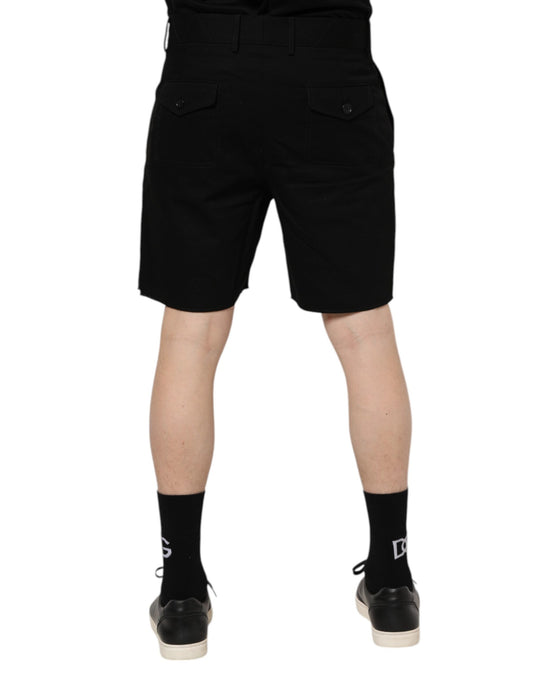 Pair of black shorts with pockets on a person